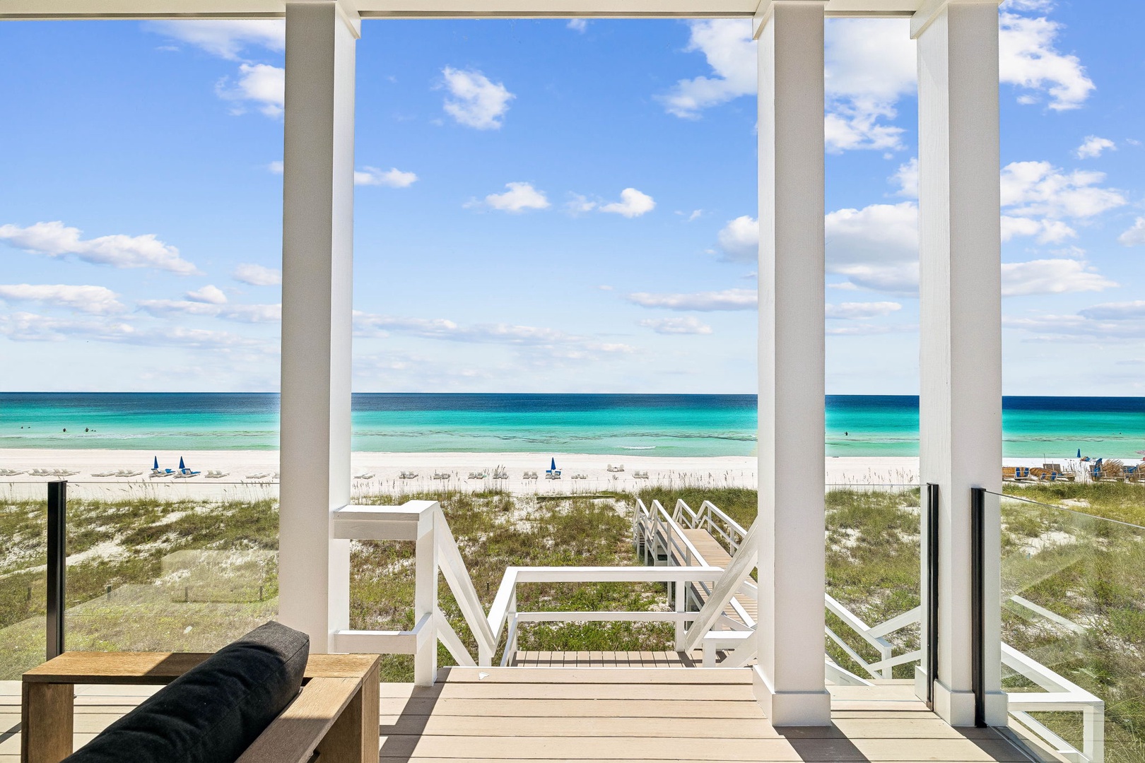 Step onto your private deck and take in unobstructed views of turquoise waters meeting powder-white sand—your perfect beachfront escape awaits just steps away.