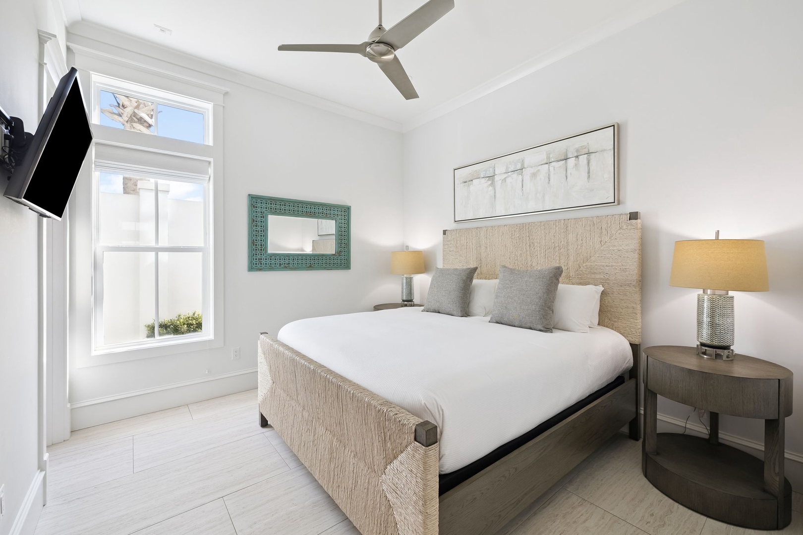 Drift peacefully into your coastal bedroom retreat with crisp white linens, natural woven textures, and warm morning light streaming through oversized windows.
