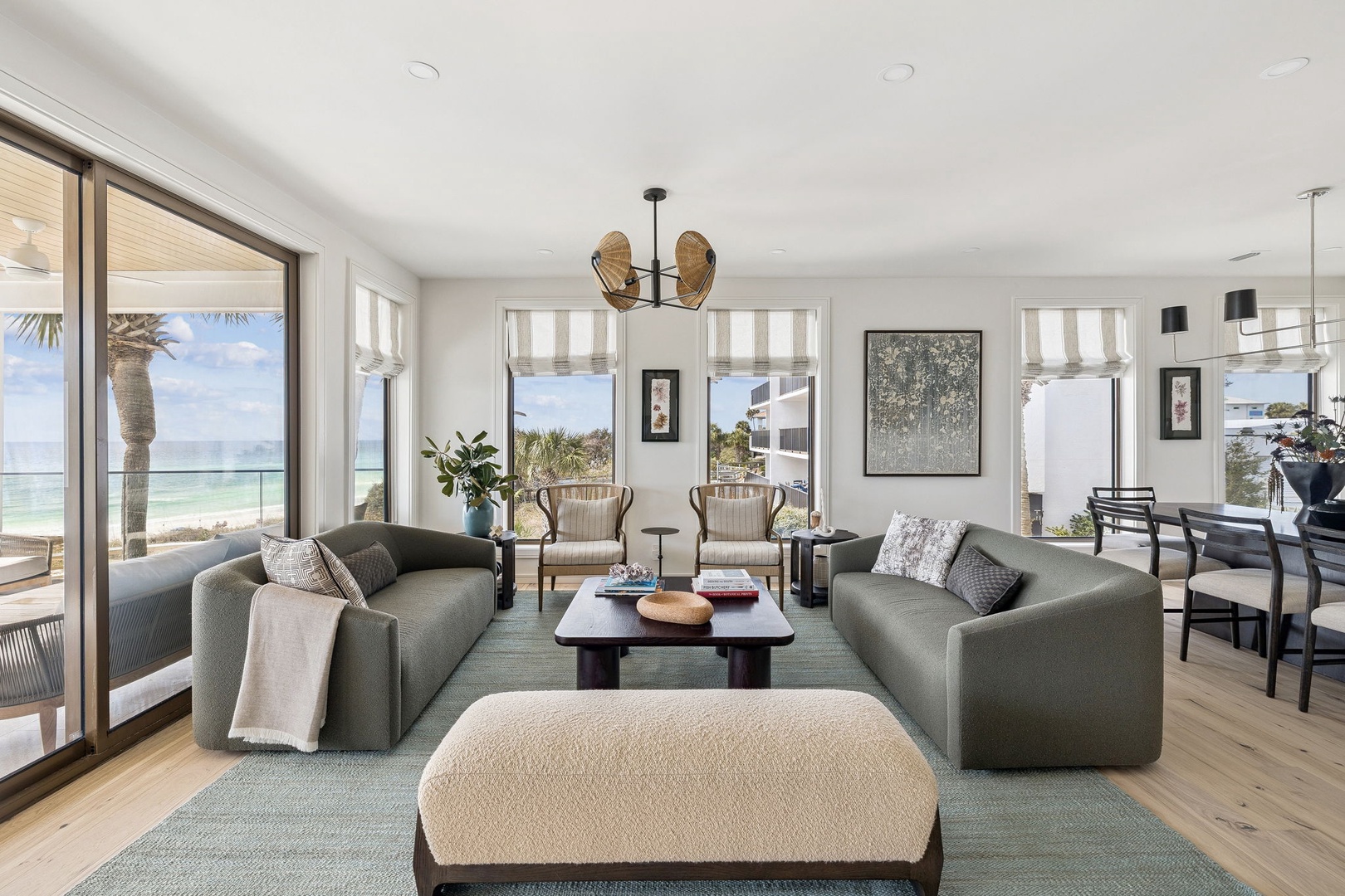 Relax in your spacious oceanfront living room where floor-to-ceiling windows frame stunning sea views and natural light fills every corner.