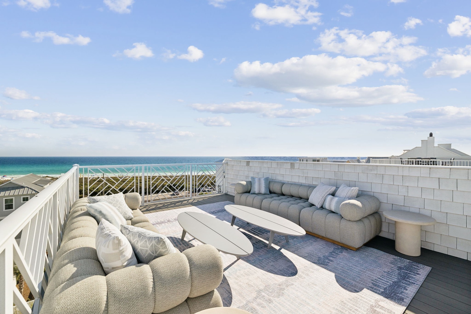 Unwind on your private rooftop terrace with plush seating and stunning ocean views stretching to the horizon.