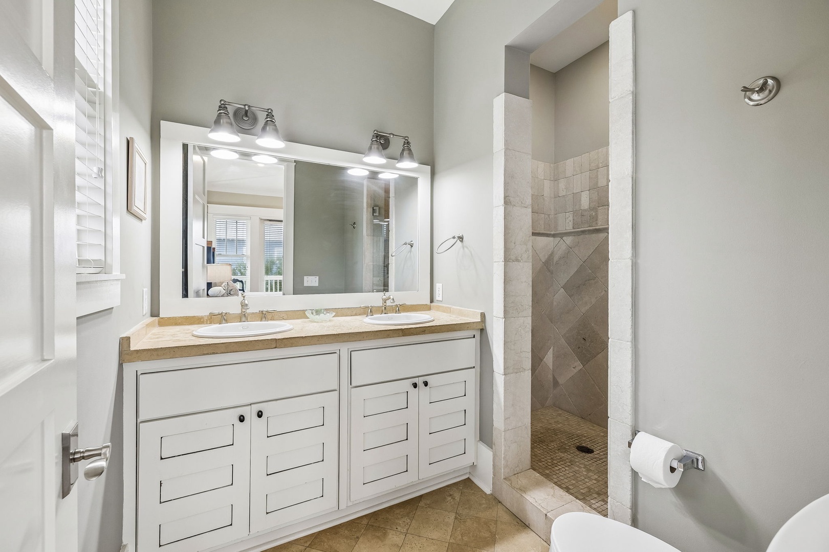 Step into your bright, elegantly designed bathroom, where dual sinks and a spacious walk-in shower await. Natural light and thoughtful touches create a calming retreat where you can refresh and prepare for your day.