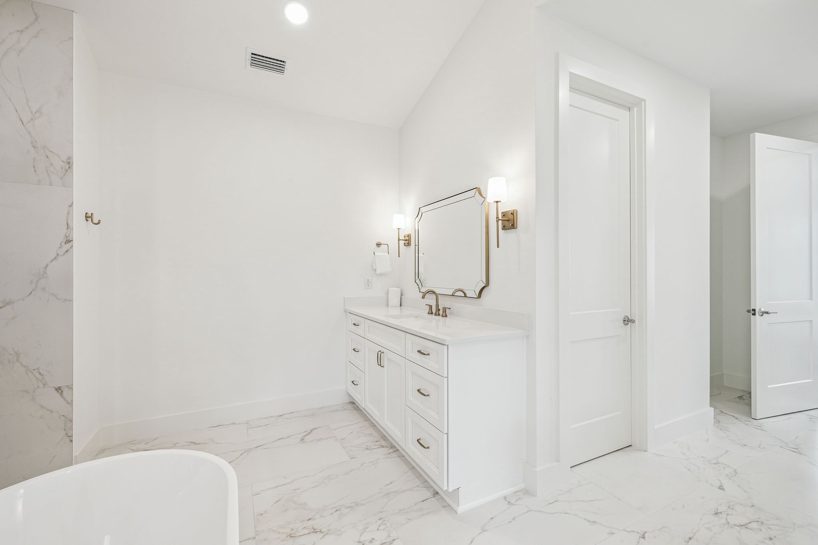 Indulge in your luxurious marble bathroom with elegant vanity, gold fixtures, and spa-like ambiance for ultimate relaxation.