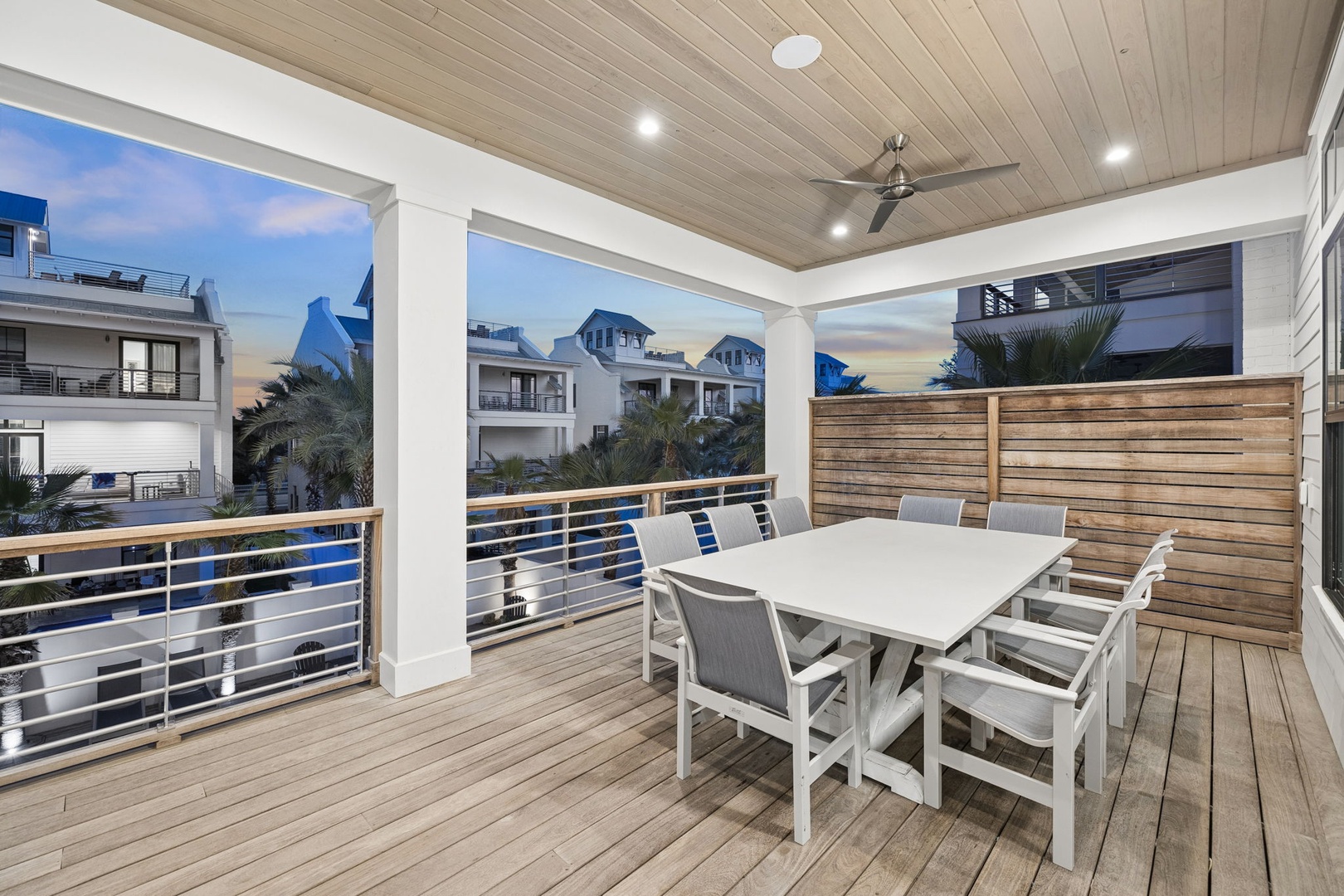Your private covered balcony features modern dining for eight with beautiful wood accents and ceiling fan for comfort.