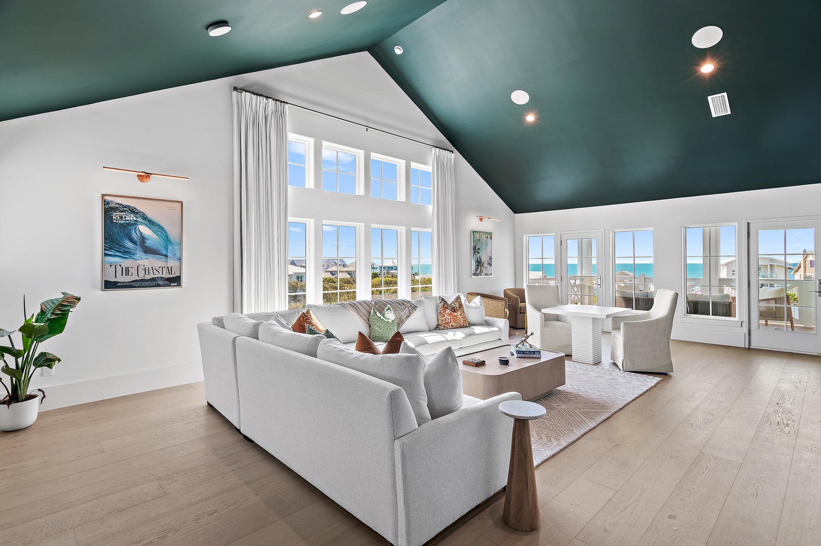 Step into your bright coastal haven where soaring ceilings meet ocean views. Sink into plush seating and let sunlight flood through walls of windows as gentle breezes and seaside calm envelop your perfect escape.