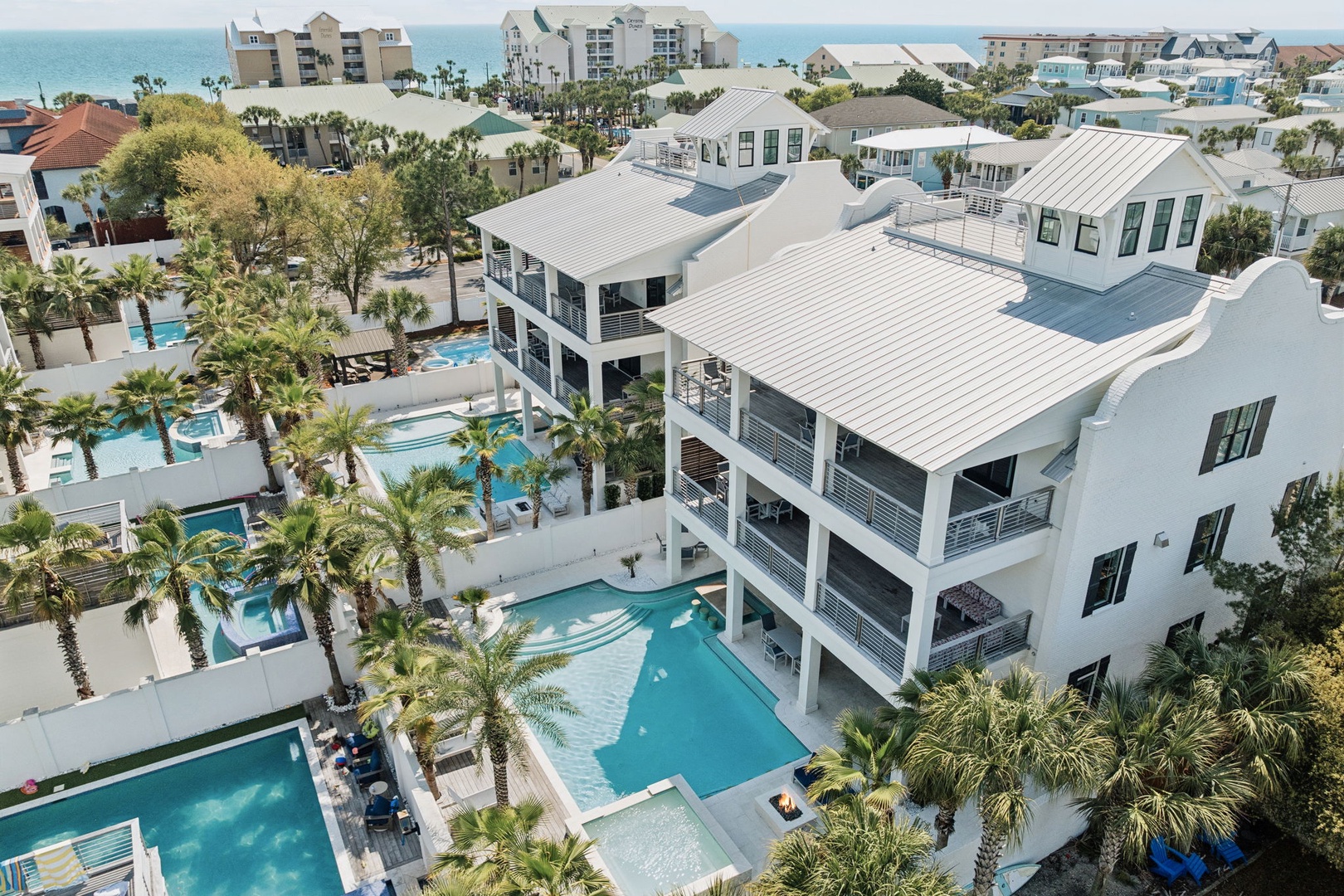 Stunning beachside property featuring luxury pools and tropical landscaping in an exclusive coastal community.