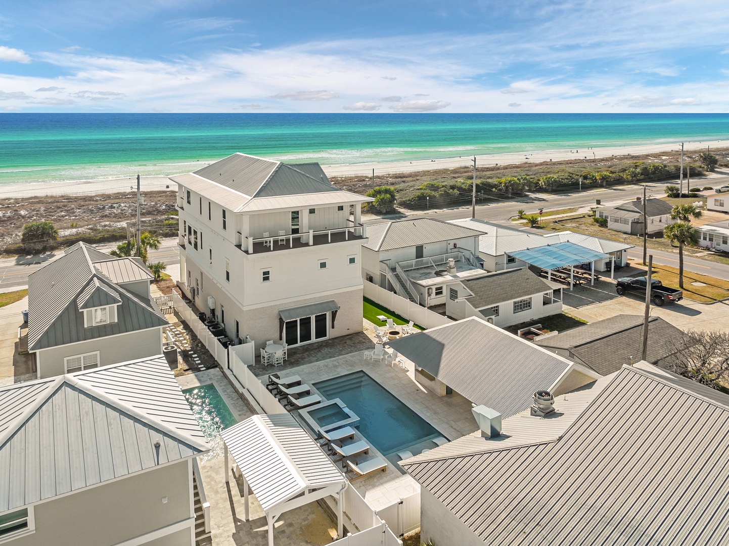 Multi-level beachfront property showcases private pool and emerald Gulf waters just steps from the pristine sandy shore.