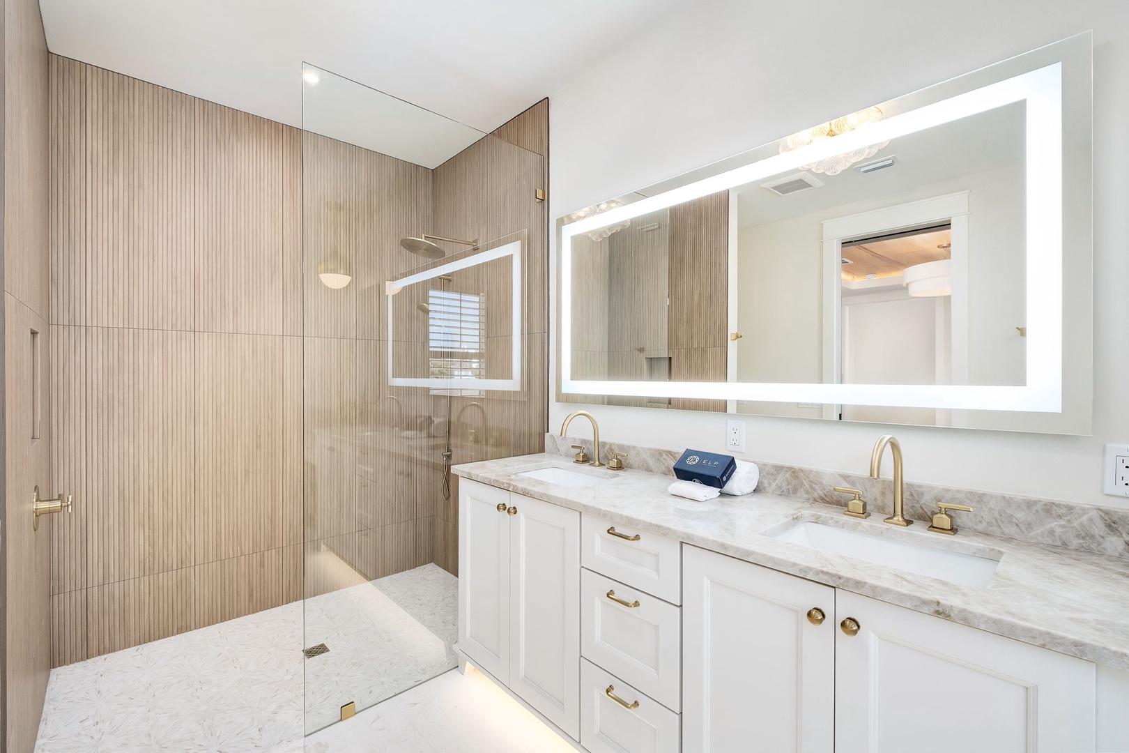 Your spa-like bathroom awaits with double vanities, elegant marble counters, and a spacious glass-enclosed shower—perfect for unwinding after a day of adventure.