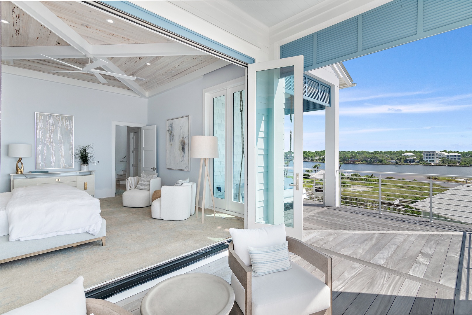 Your serene coastal retreat features floor-to-ceiling windows that frame stunning water views. Drift off in the luxurious bed or relax on your private deck overlooking tranquil shores.