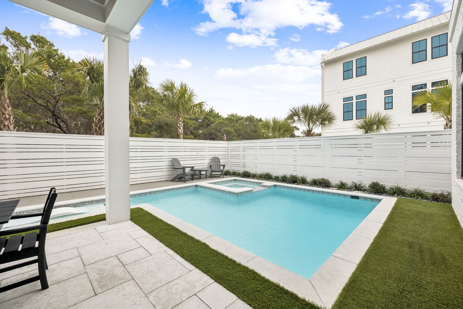 Your private paradise awaits with a sparkling pool and spa surrounded by lush landscaping and modern comfort.