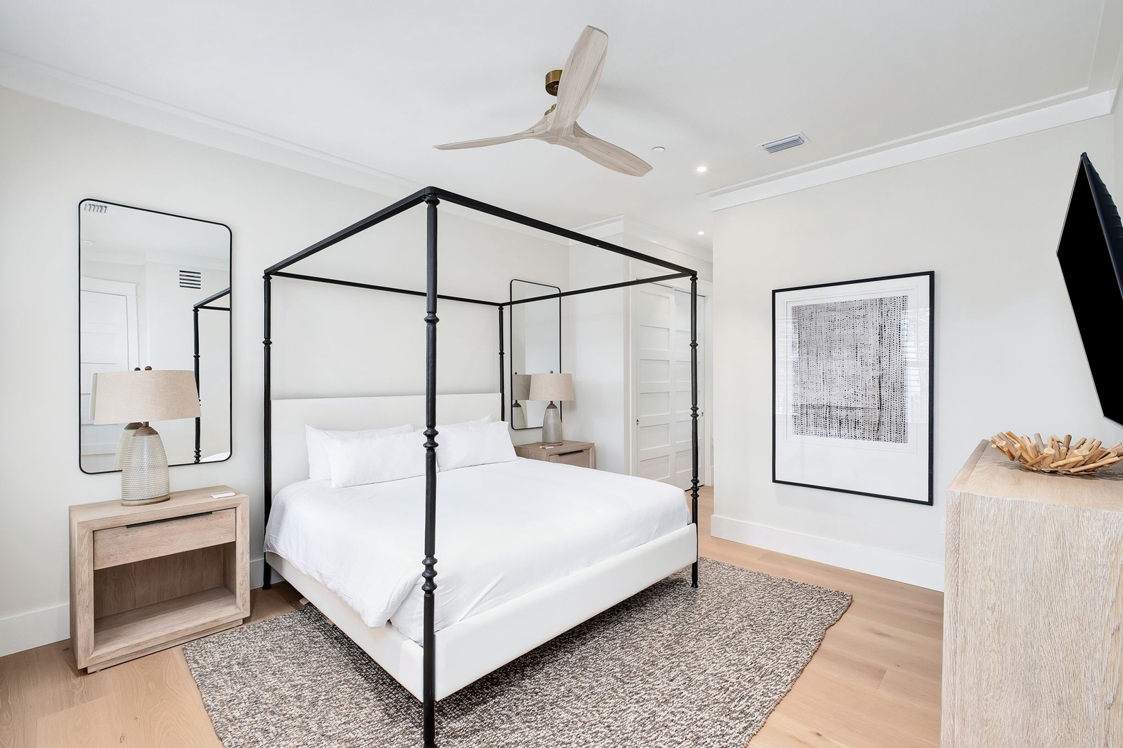 Slip into crisp white linens and feel the soft ceiling fan above as you unwind in your serene canopy bed retreat.