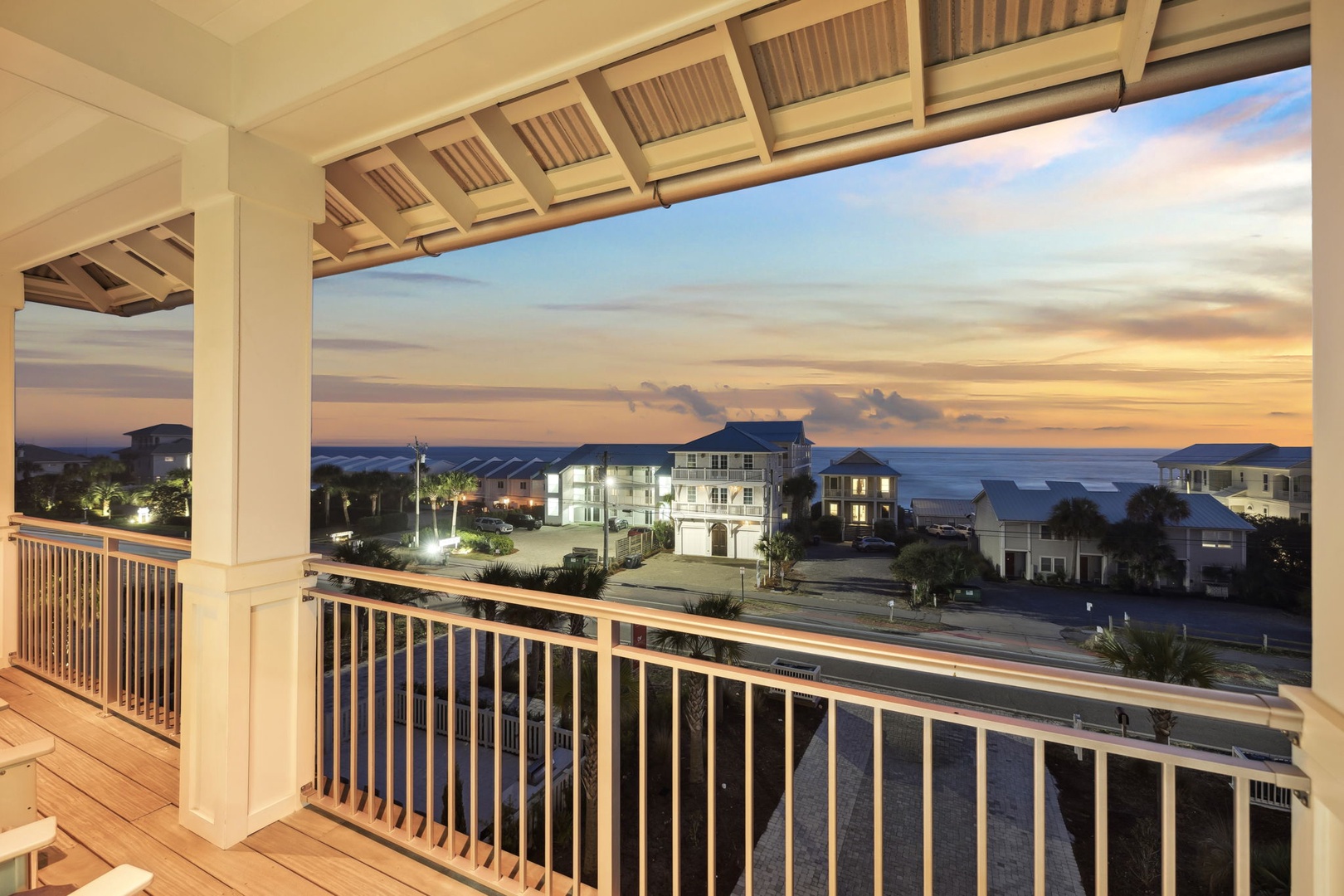 Your private balcony offers stunning sunset views over the coastal neighborhood, perfect for evening relaxation with your favorite beverage.