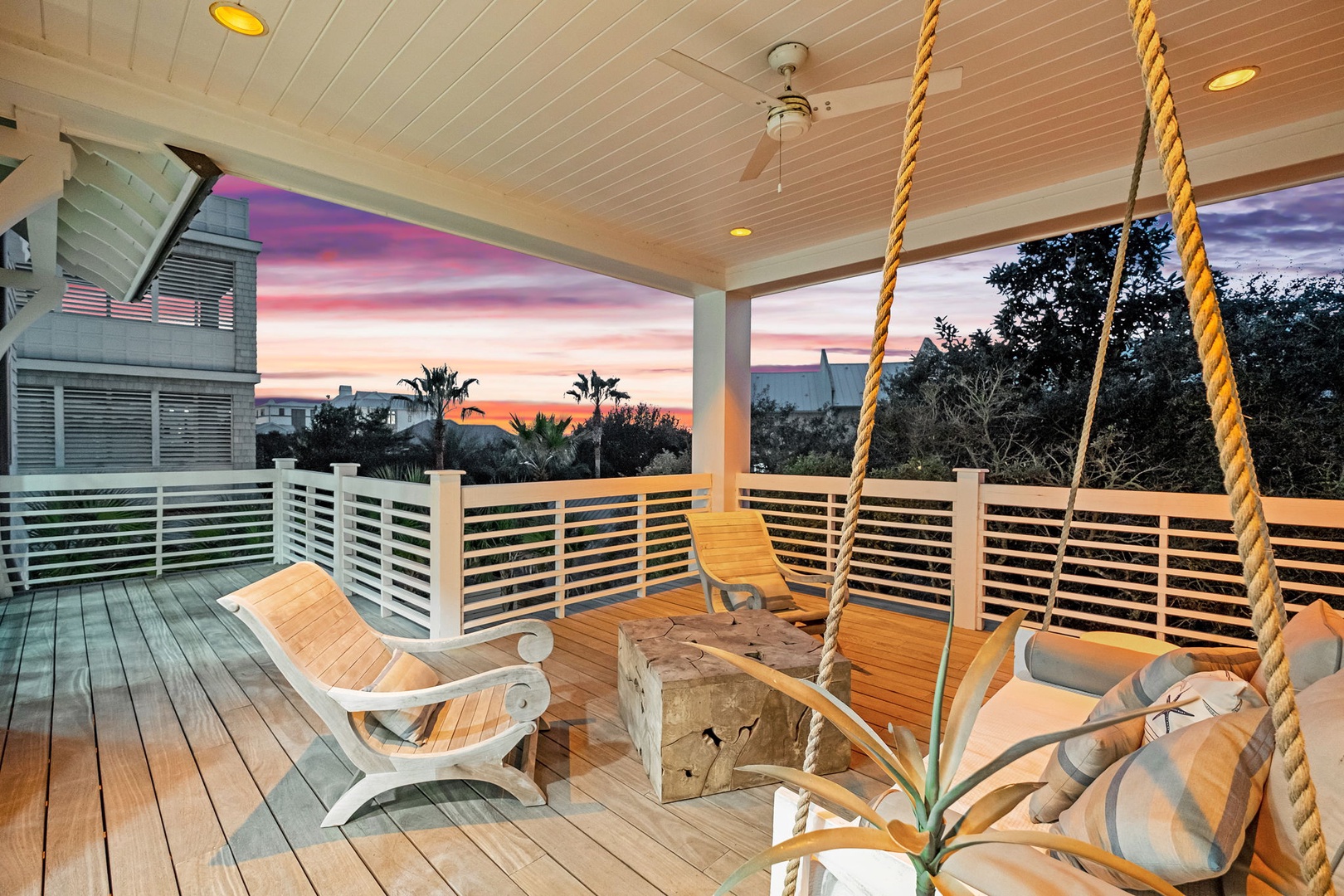 Unwind on your private deck with a rope swing and lounge chairs as stunning sunset colors paint the sky beyond.