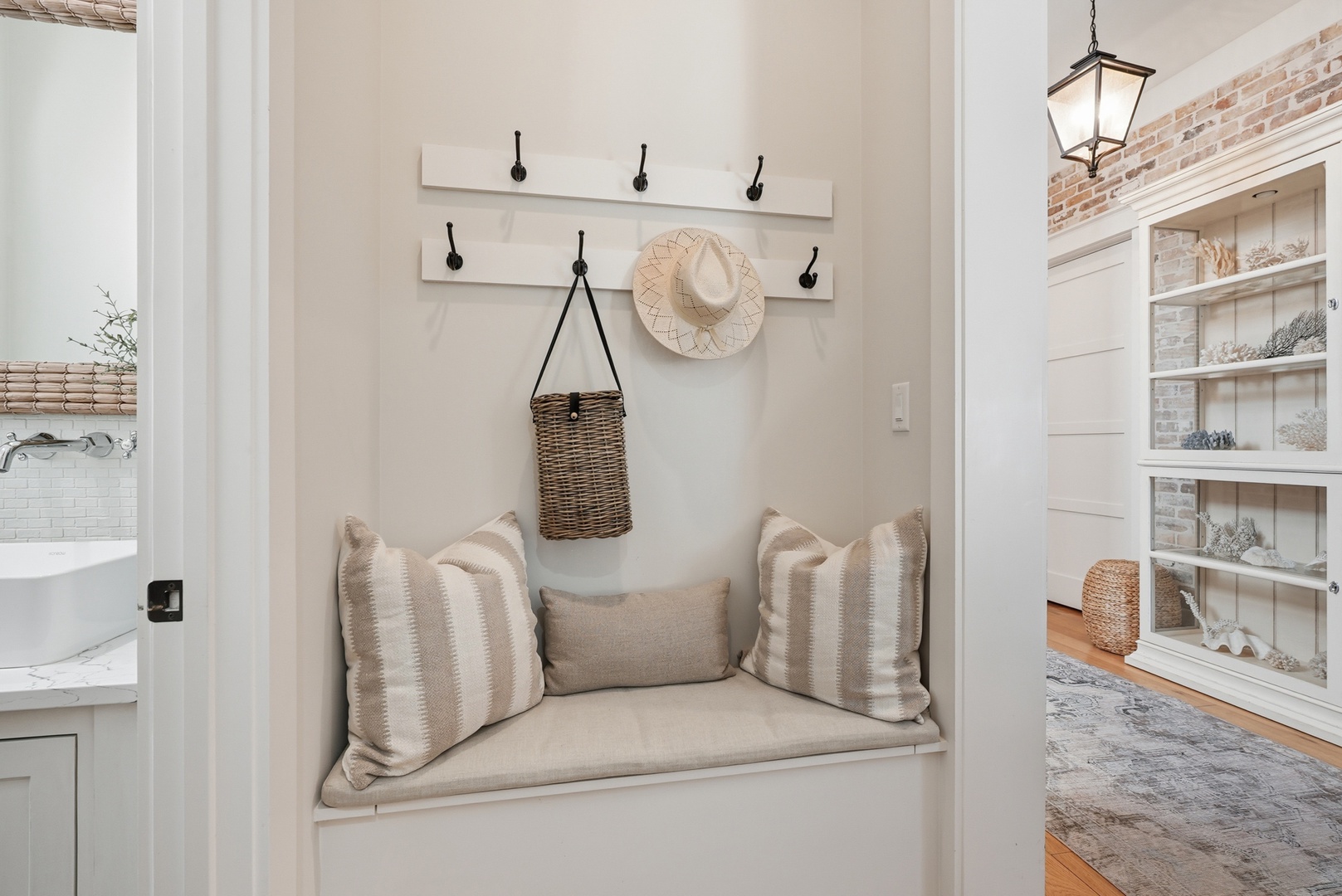Settle into this cozy nook with soft cushions, perfect for curling up with a book or sipping morning coffee. The built-in bench and warm coastal touches create your personal hideaway.