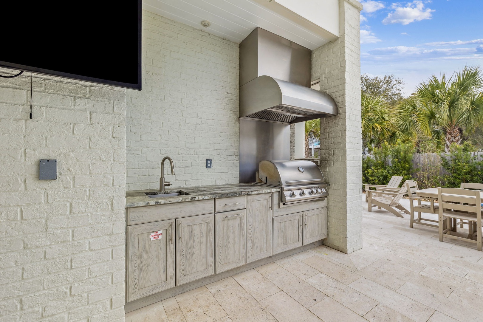 Your outdoor kitchen awaits with a premium grill and granite counters, perfect for cooking al fresco while enjoying tropical views.