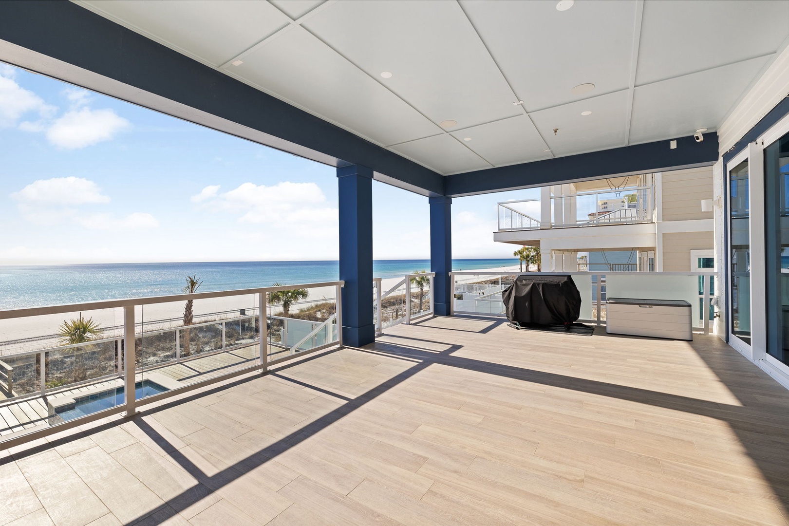 Step onto your expansive covered terrace where stunning ocean views stretch endlessly before you, creating the perfect backdrop for morning coffee or evening relaxation.