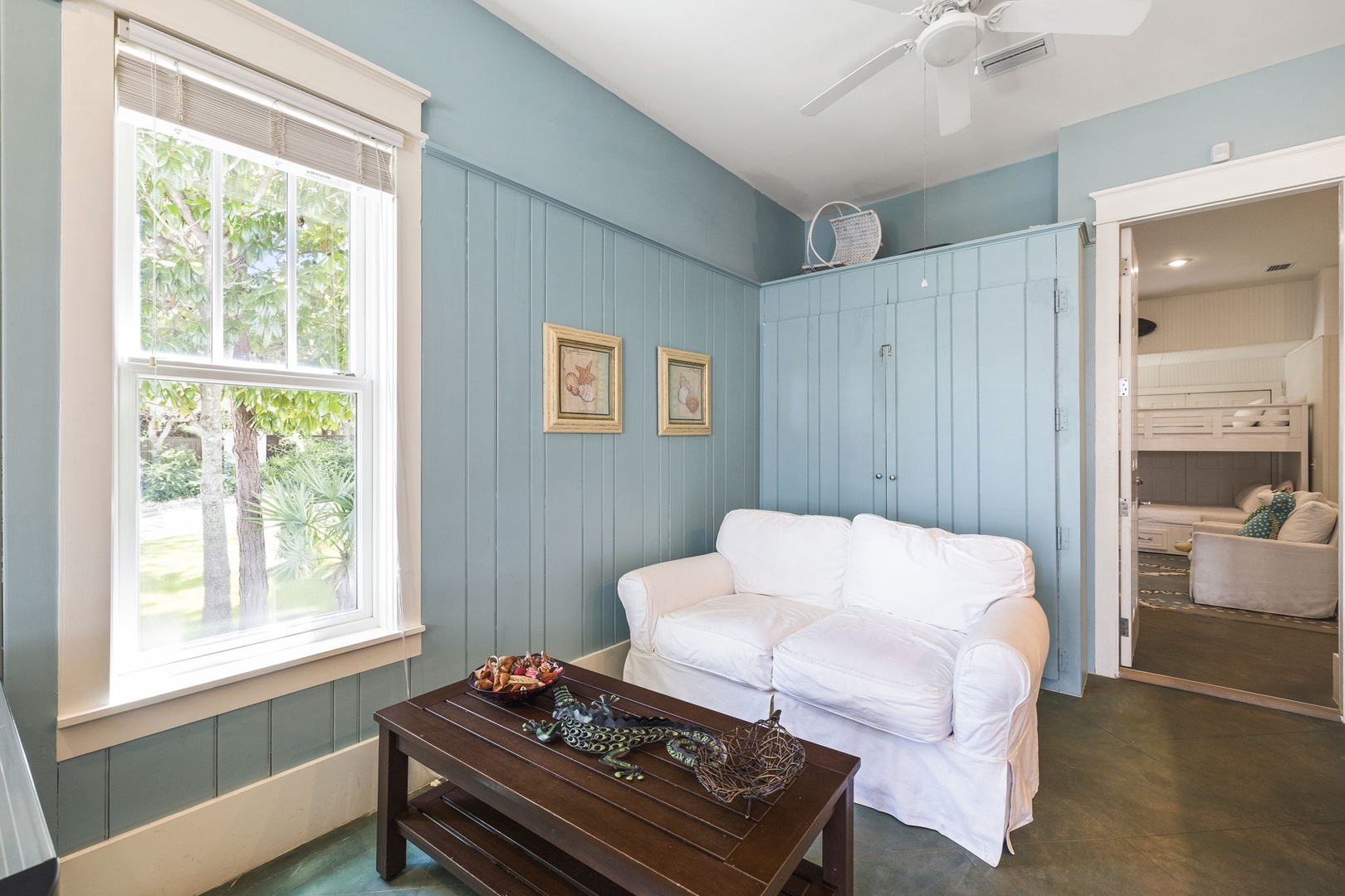 Sink into the plush white couch and unwind in this serene coastal-style living space, where soft blues and warm textures create your perfect retreat.