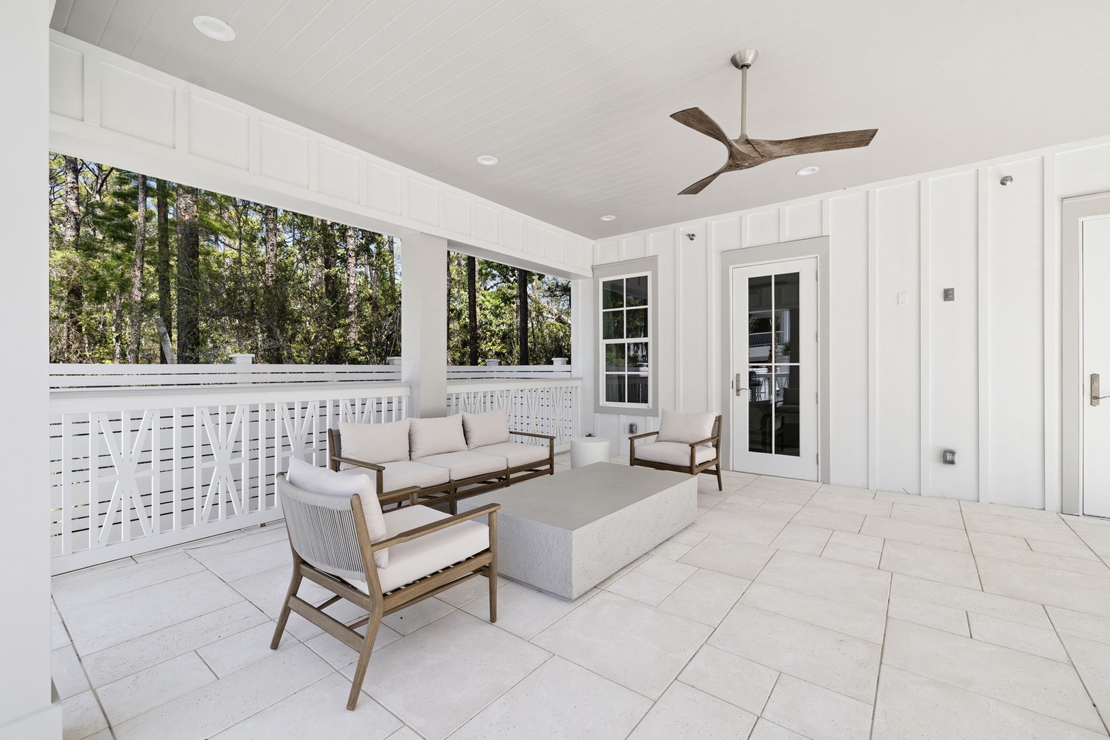 Relax on your private covered porch with stylish seating surrounded by lush forest views—perfect for morning coffee or evening unwind.