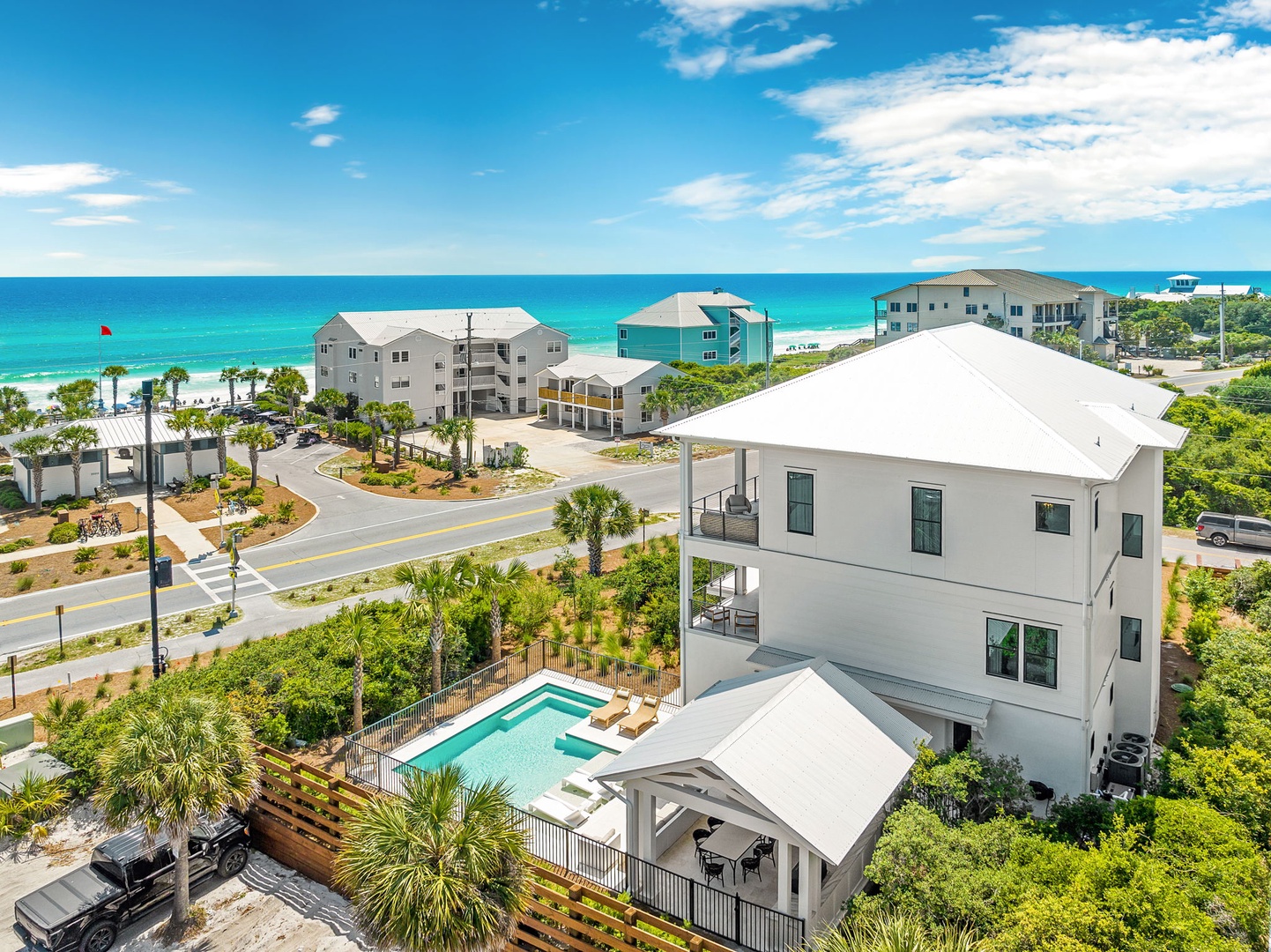 This beachside property features a private pool and spacious outdoor areas, perfectly positioned just steps from stunning turquoise waters and pristine white sand beaches.