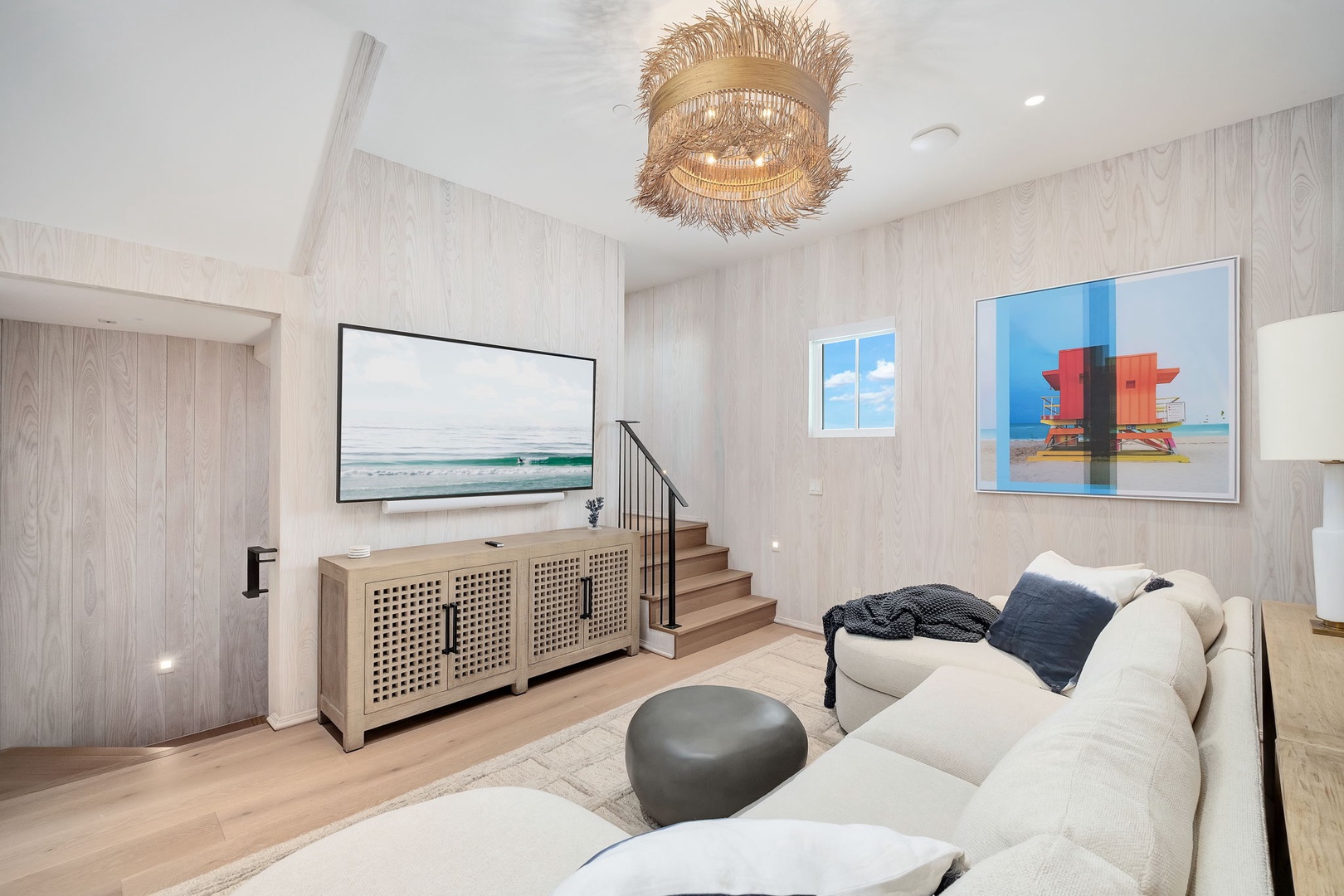 Sink into the plush sectional and let the soft coastal palette wash over you—this airy living room is your perfect place to unwind after a day of exploring.