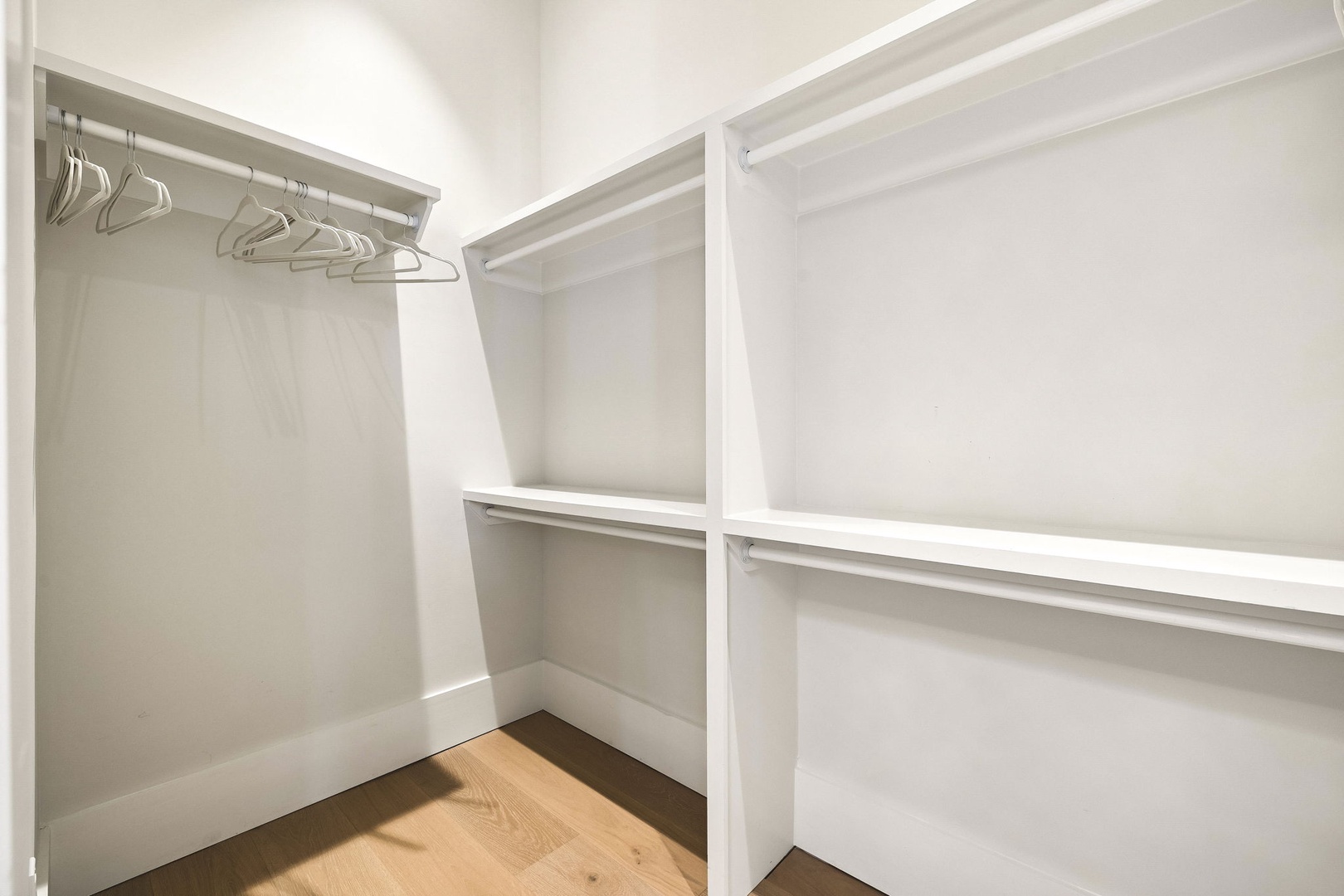 Your spacious walk-in closet offers plenty of room to settle in, with custom shelving and hanging rods ready for all your belongings.