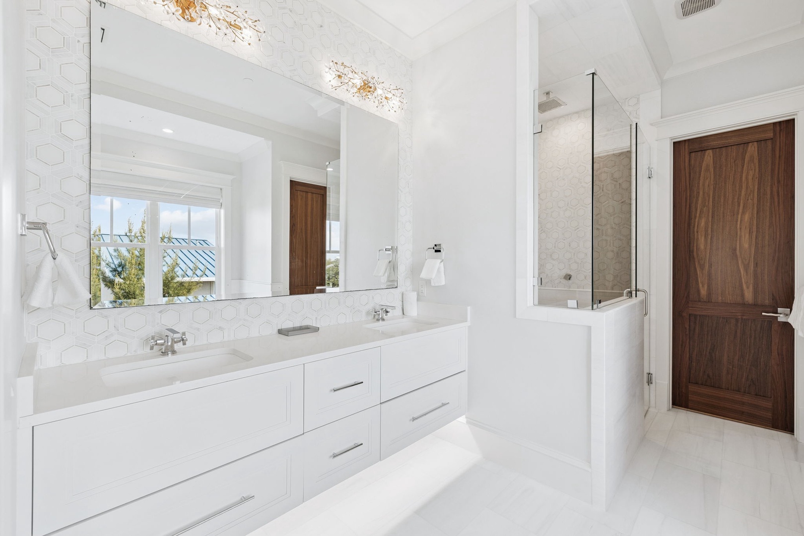 Your spa-like master bathroom features dual vanities, elegant marble countertops, and a spacious glass shower for ultimate relaxation.