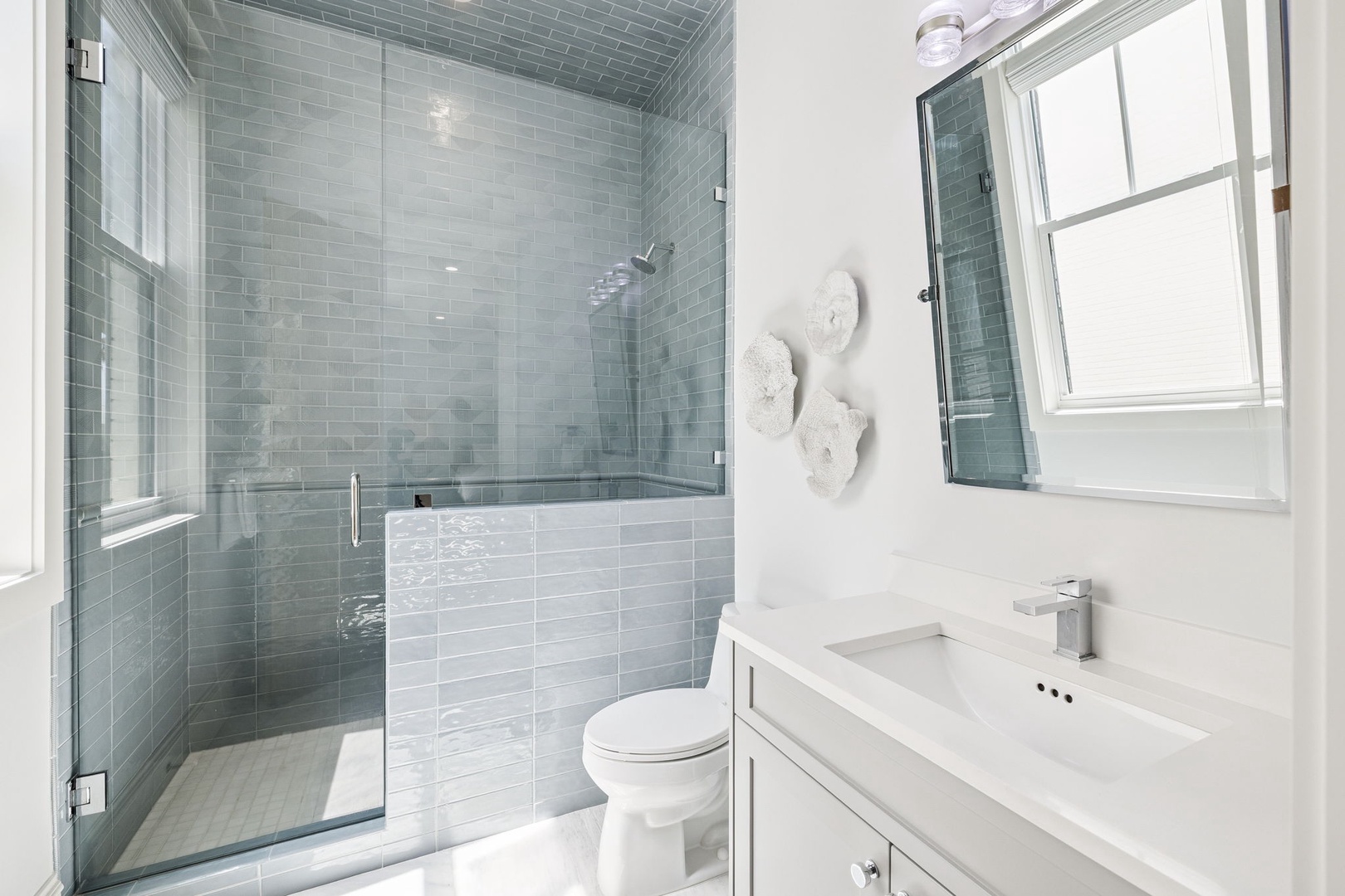 Step into your spa-like bathroom featuring stunning sea-glass tiles and a luxurious walk-in shower where you can unwind after your adventures.