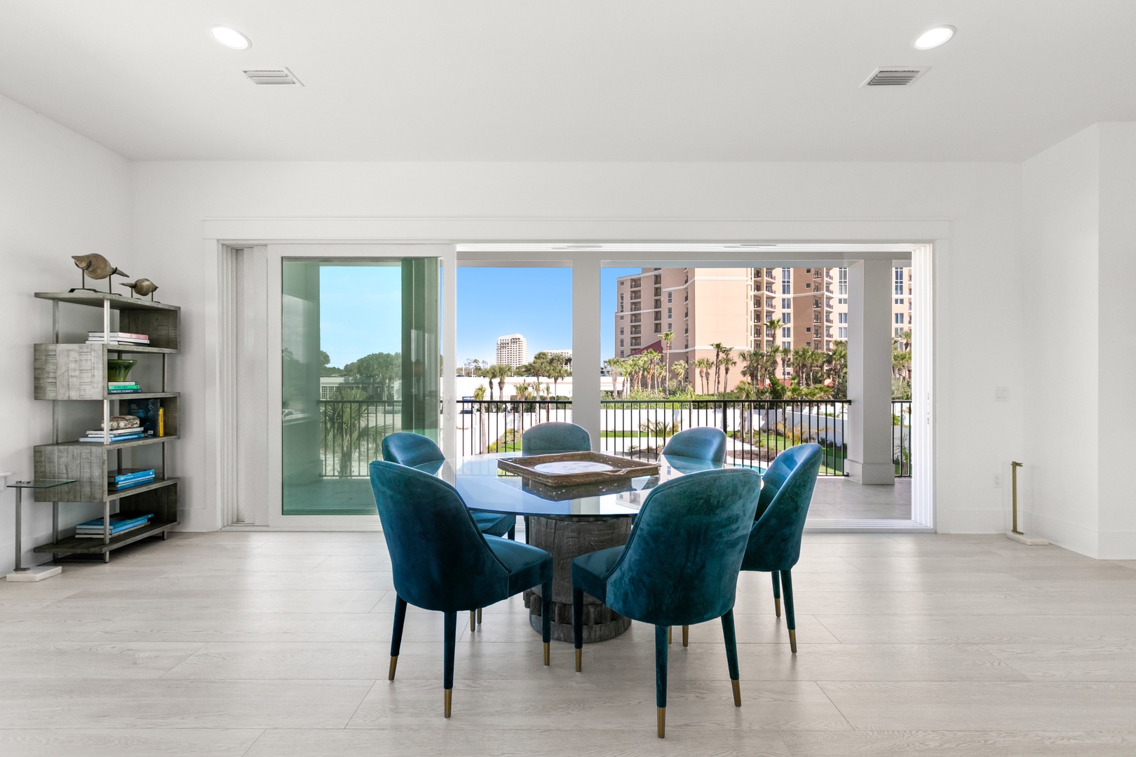 Picture yourself savoring morning coffee at this elegant dining table, framed by sweeping doors that open to your private balcony and sparkling waterfront views beyond.