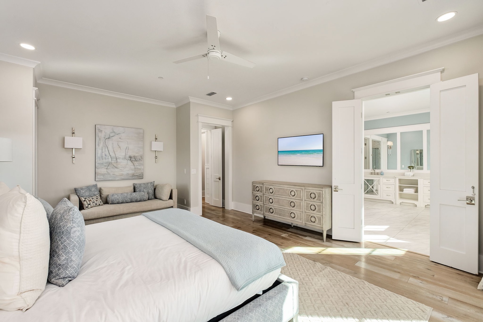 Your spacious master suite offers coastal elegance with plush bedding, built-in seating nook, and an ensuite bathroom for ultimate comfort.