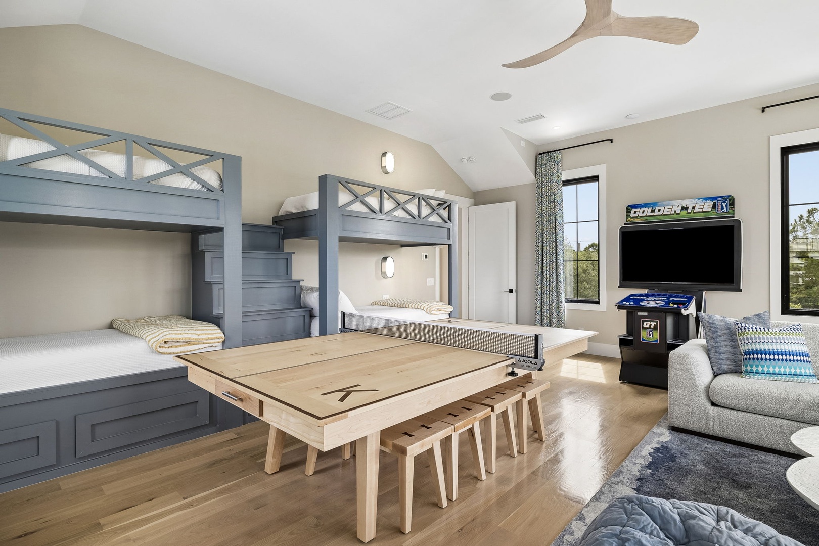 Your group will love this spacious kids' room with custom bunk beds, a game table for laughter-filled evenings, and an arcade game for friendly competition.
