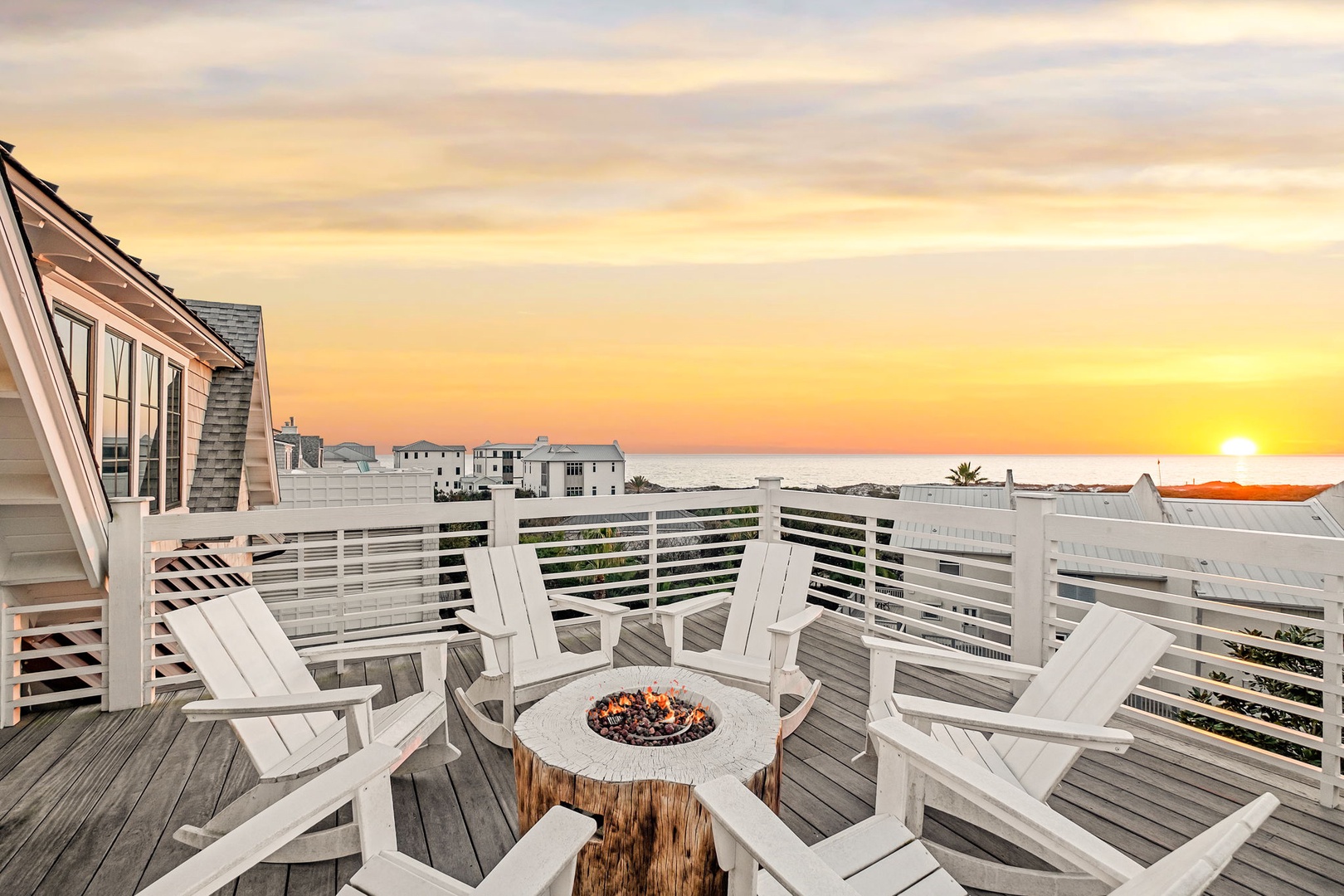 Sunset views from your private deck create the perfect backdrop for evening conversations around the cozy fire pit.