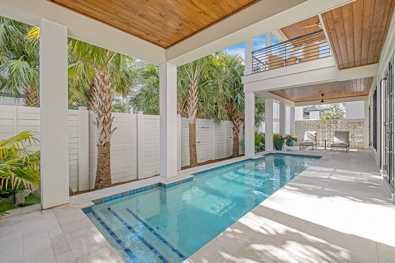 Your private pool oasis awaits, framed by swaying palms and elegant columns where you can splash, relax, and escape in tropical luxury.