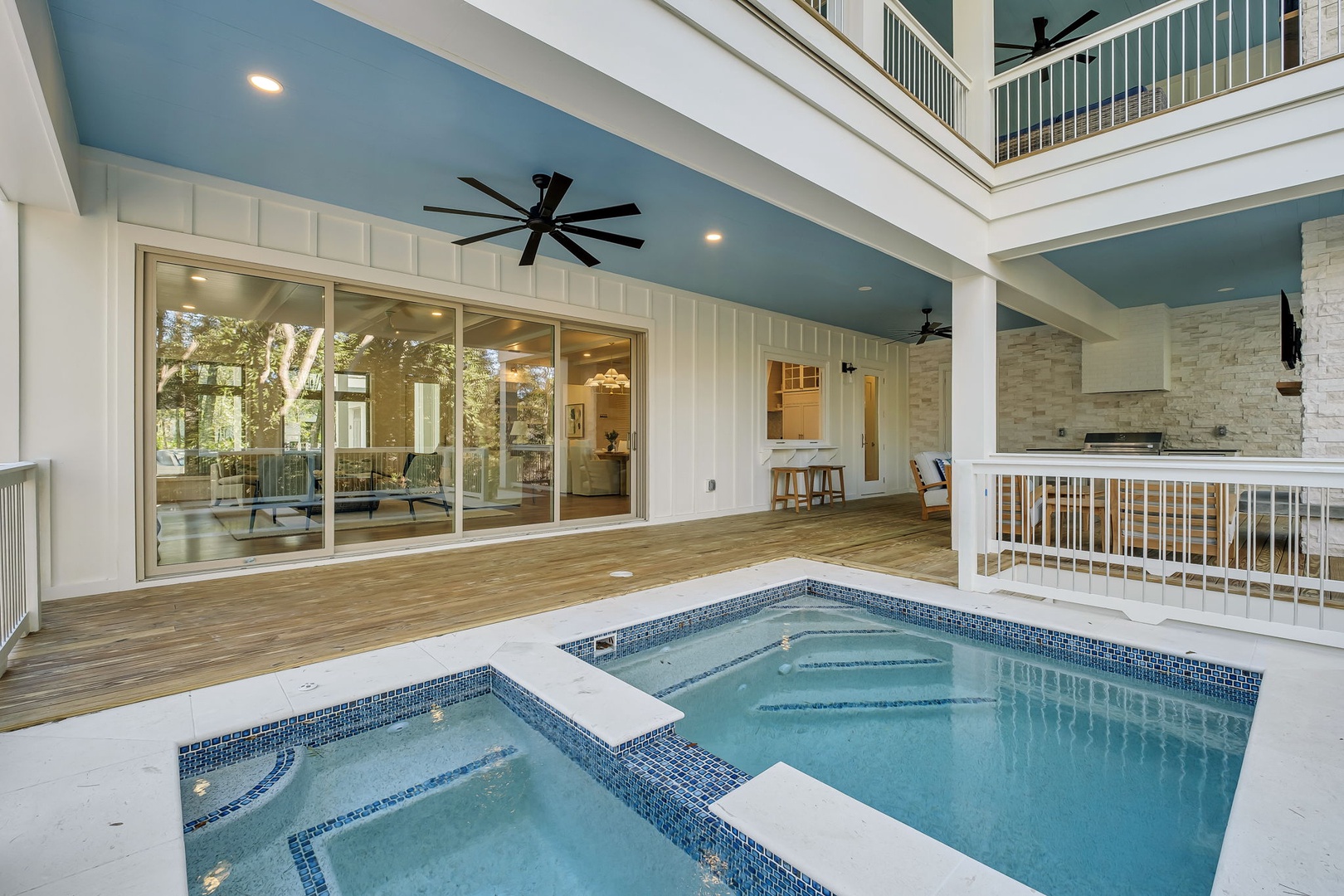 Unwind in your private hot tub oasis under soaring ceilings with elegant coastal design.