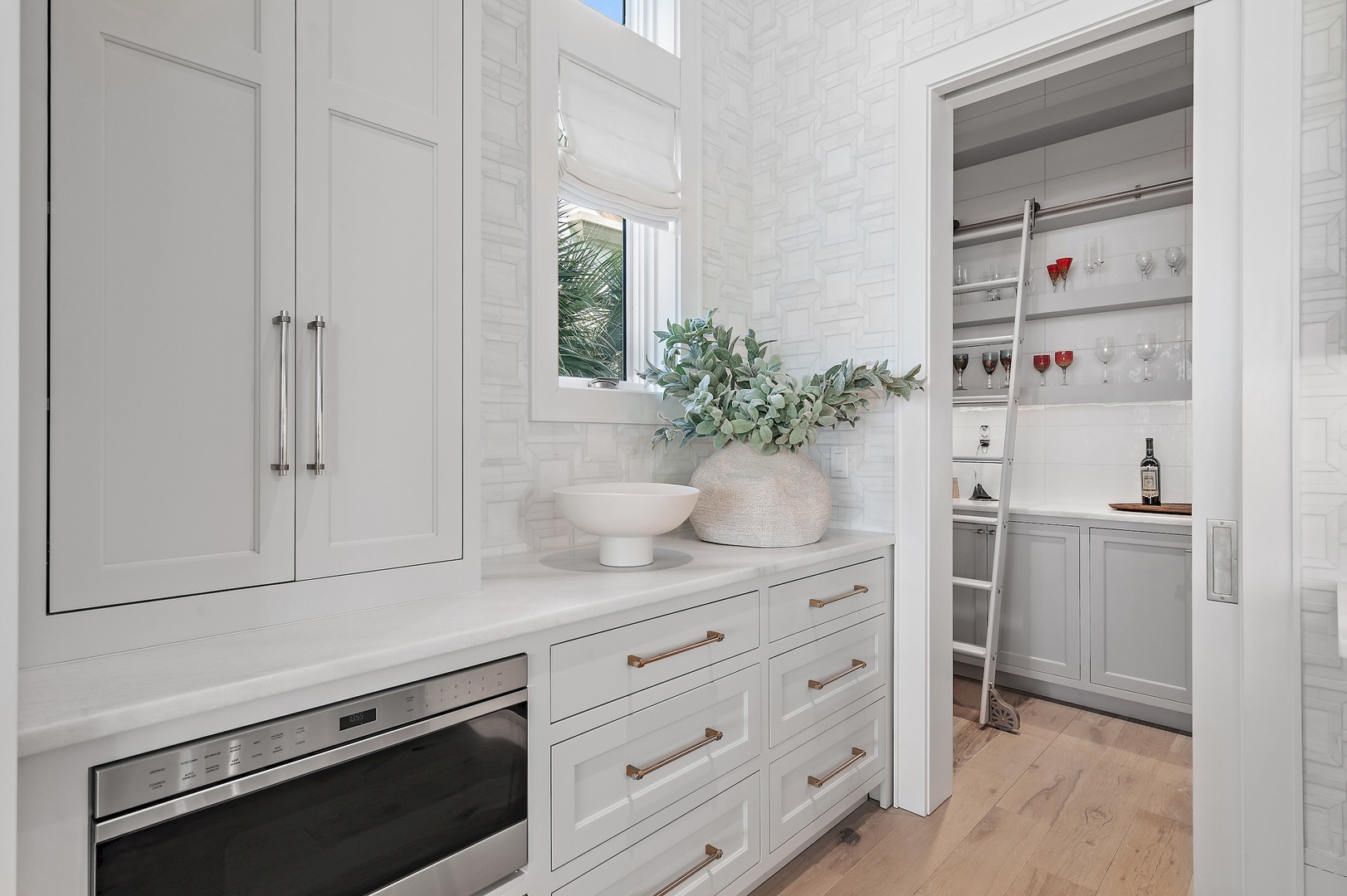 Your kitchen extends seamlessly into a stylish beverage nook, complete with built-in storage and a thoughtfully designed bar area—perfect for unwinding after a long day.