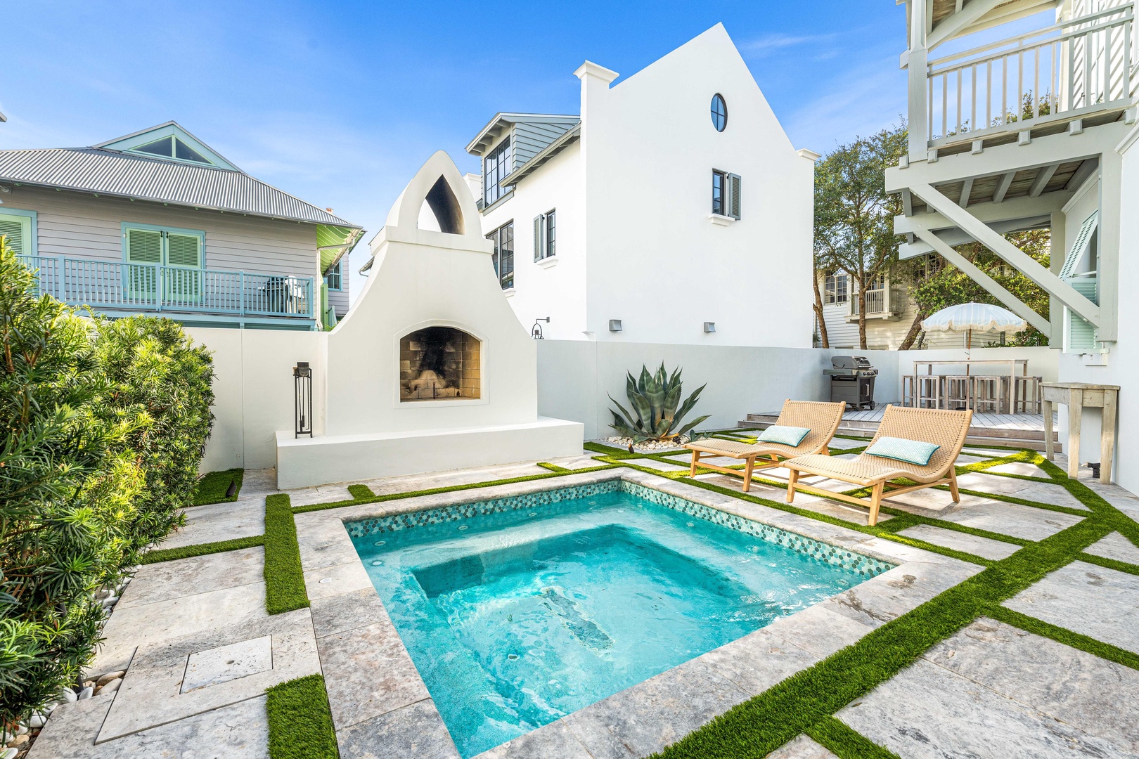 Your private oasis awaits with a sparkling pool, cozy fireplace, and sun loungers perfect for lazy afternoons.