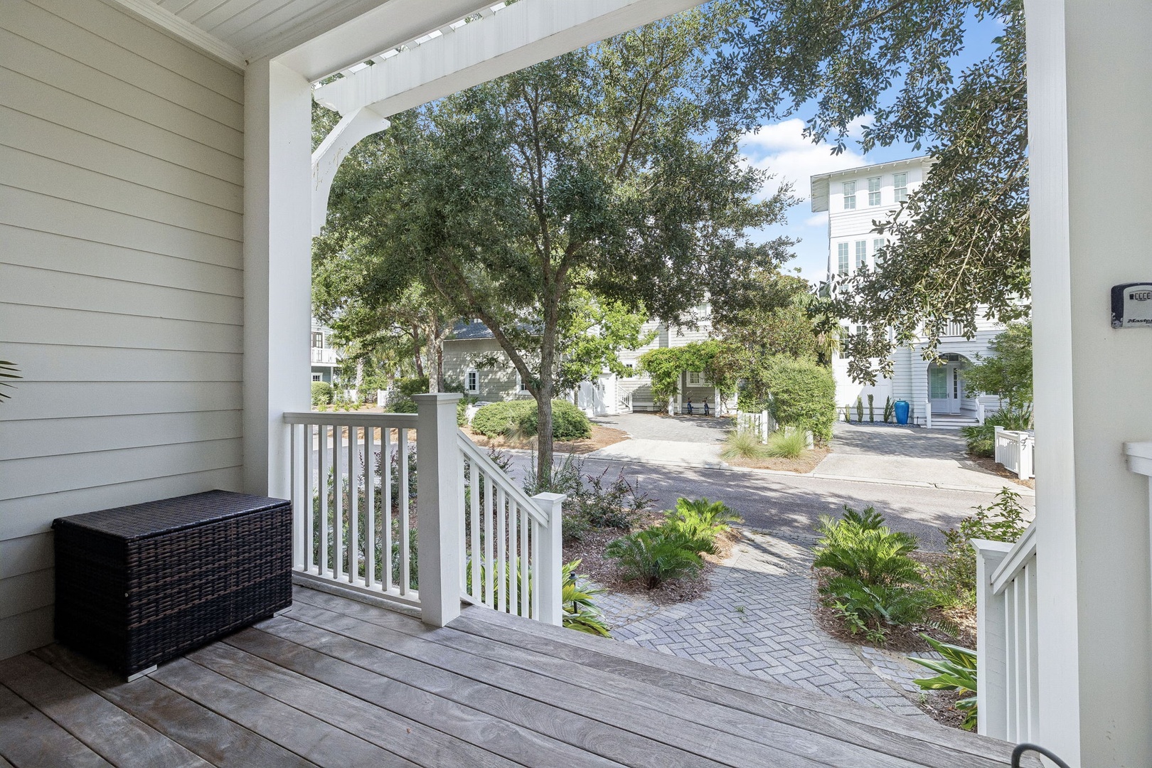 Step out onto your private porch and breathe in the coastal breeze. Tree-lined pathways and neighboring homes create a peaceful retreat just steps from your door.