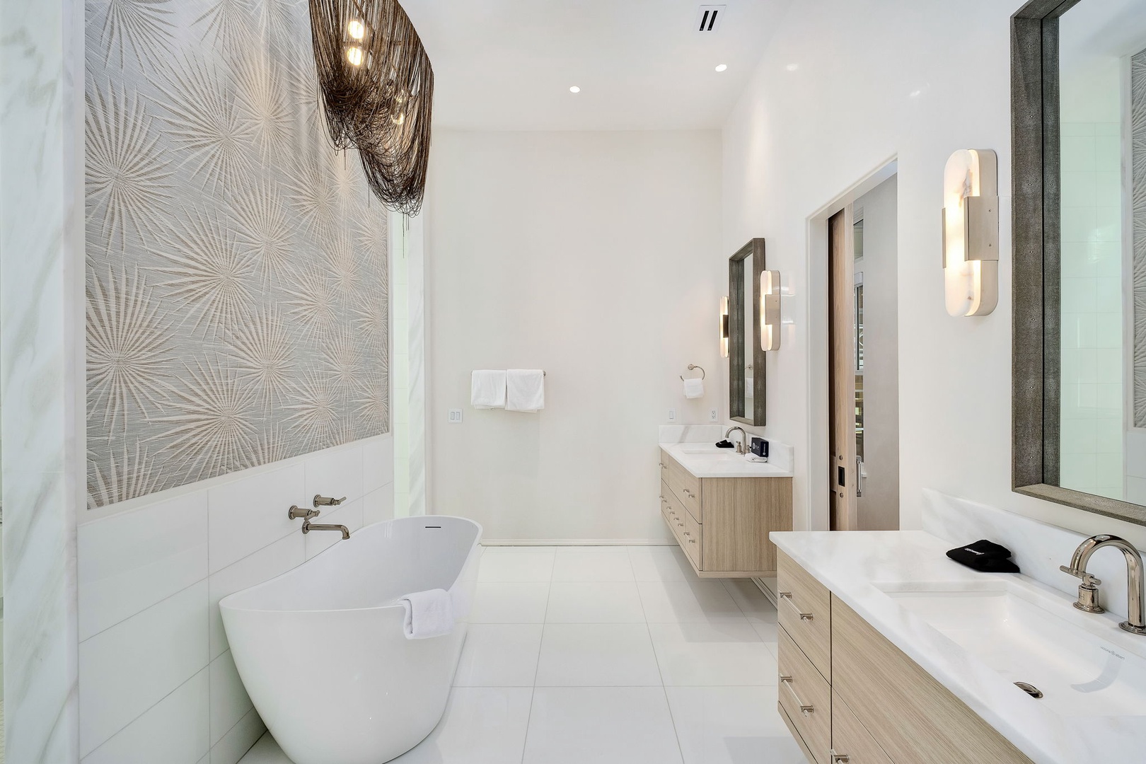 Step into your spa-like sanctuary. Sleek fixtures, a sculptural soaking tub, and serene design details invite you to unwind completely.