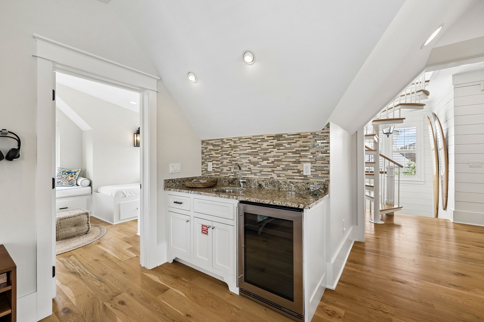 Your upstairs haven includes a charming kitchenette with sleek granite counters and a mini fridge—perfect for grabbing a cold drink without heading downstairs.