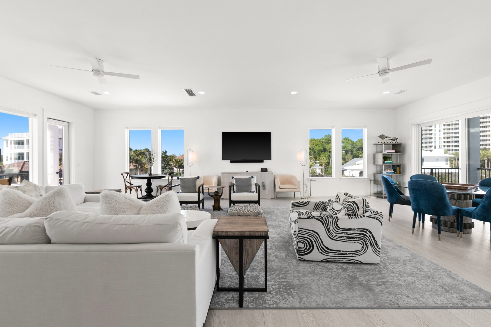 Picture yourself relaxing in this bright, open living space with soaring ceilings and multiple seating areas. Large windows frame the surrounding neighborhood, filling your retreat with natural light throughout the day.