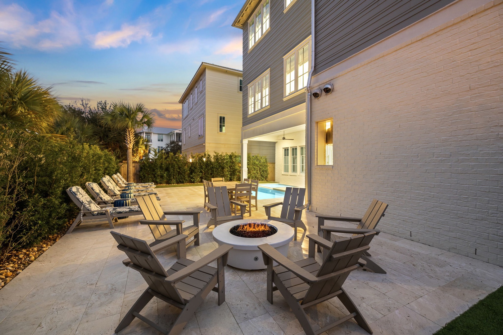 Gather around your private fire pit as twilight paints the sky, sharing stories while flames dance warmly between comfortable chairs.