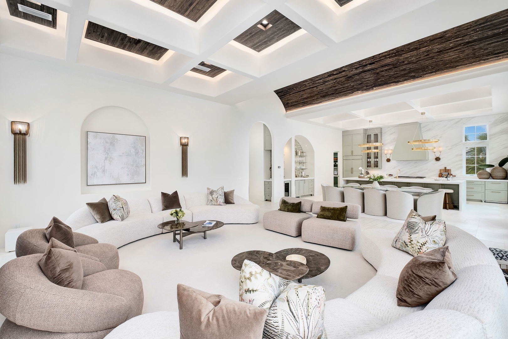 Sink into plush seating beneath soaring coffered ceilings, where natural light and rustic wood beams create a serene, airy retreat. The open-concept design flows effortlessly into your gourmet kitchen, perfect for unwinding after a day exploring.