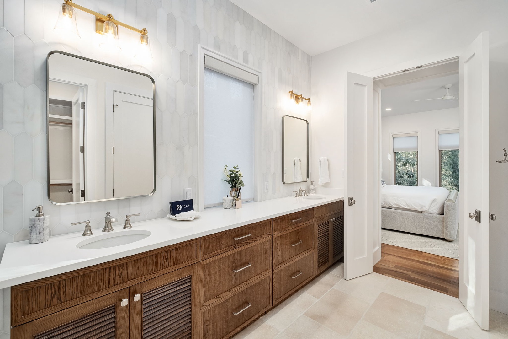 Luxurious master bathroom with dual vanities, elegant lighting, and marble countertops creates your perfect morning routine sanctuary.