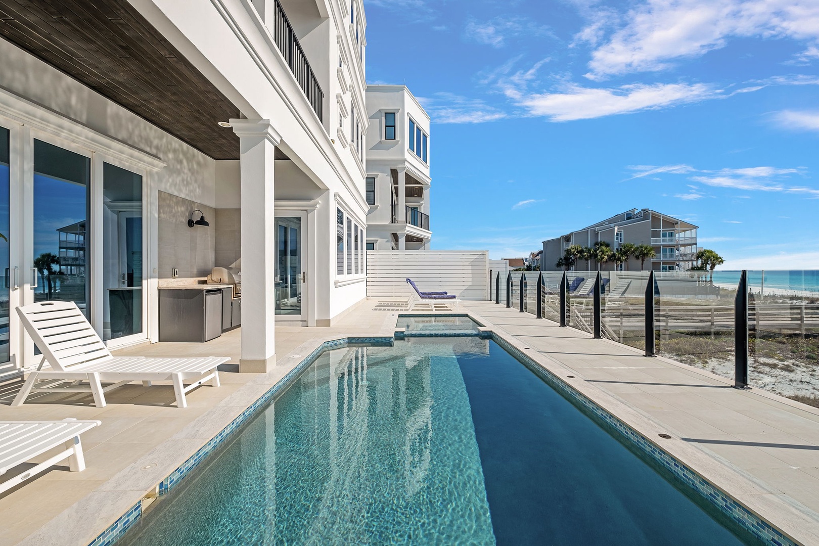 Modern beachfront home with private pool, outdoor kitchen, and stunning ocean access just steps away.