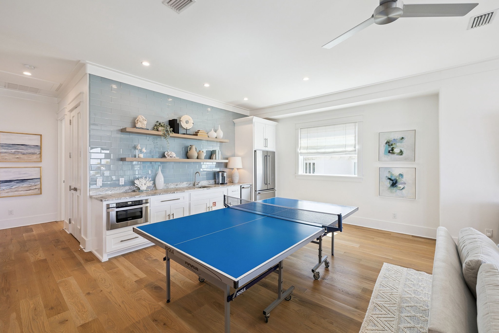 Challenge friends to a game of ping pong in your spacious recreation room, complete with a modern kitchen for post-match snacks and refreshments.