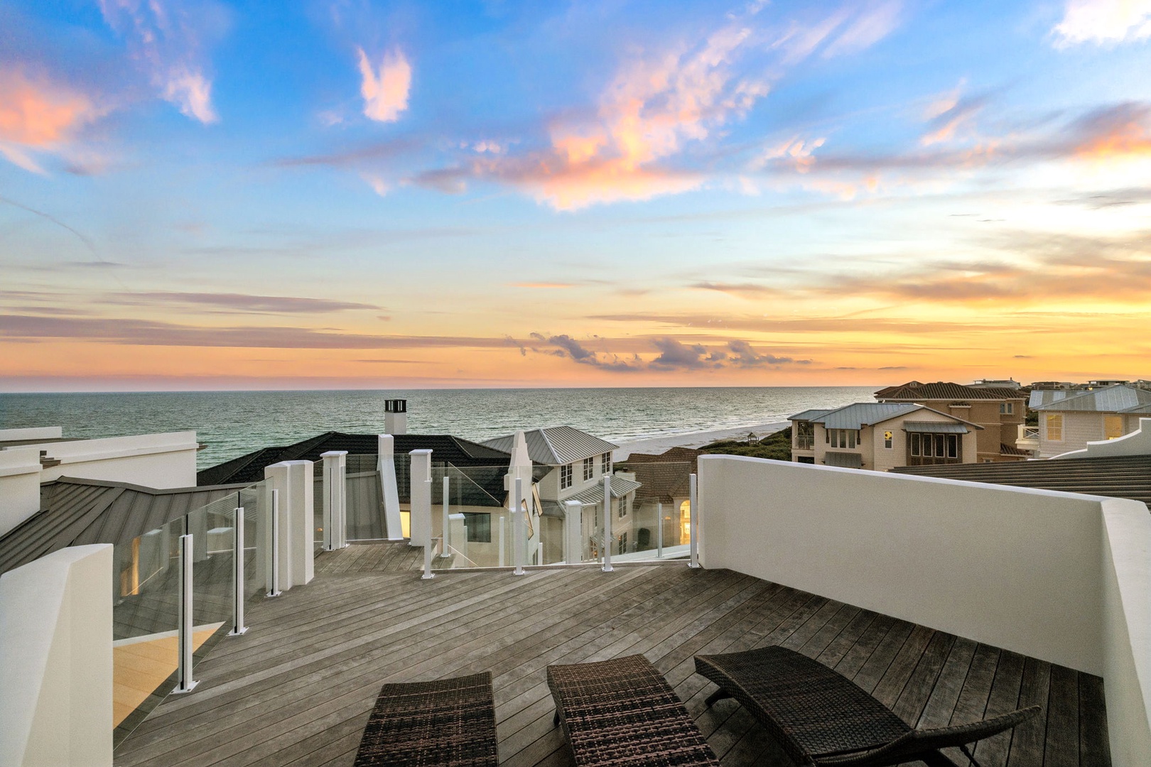 A stunning rooftop terrace where you can unwind with breathtaking sea views, colorful sunsets, and peaceful lounge seating under open skies.