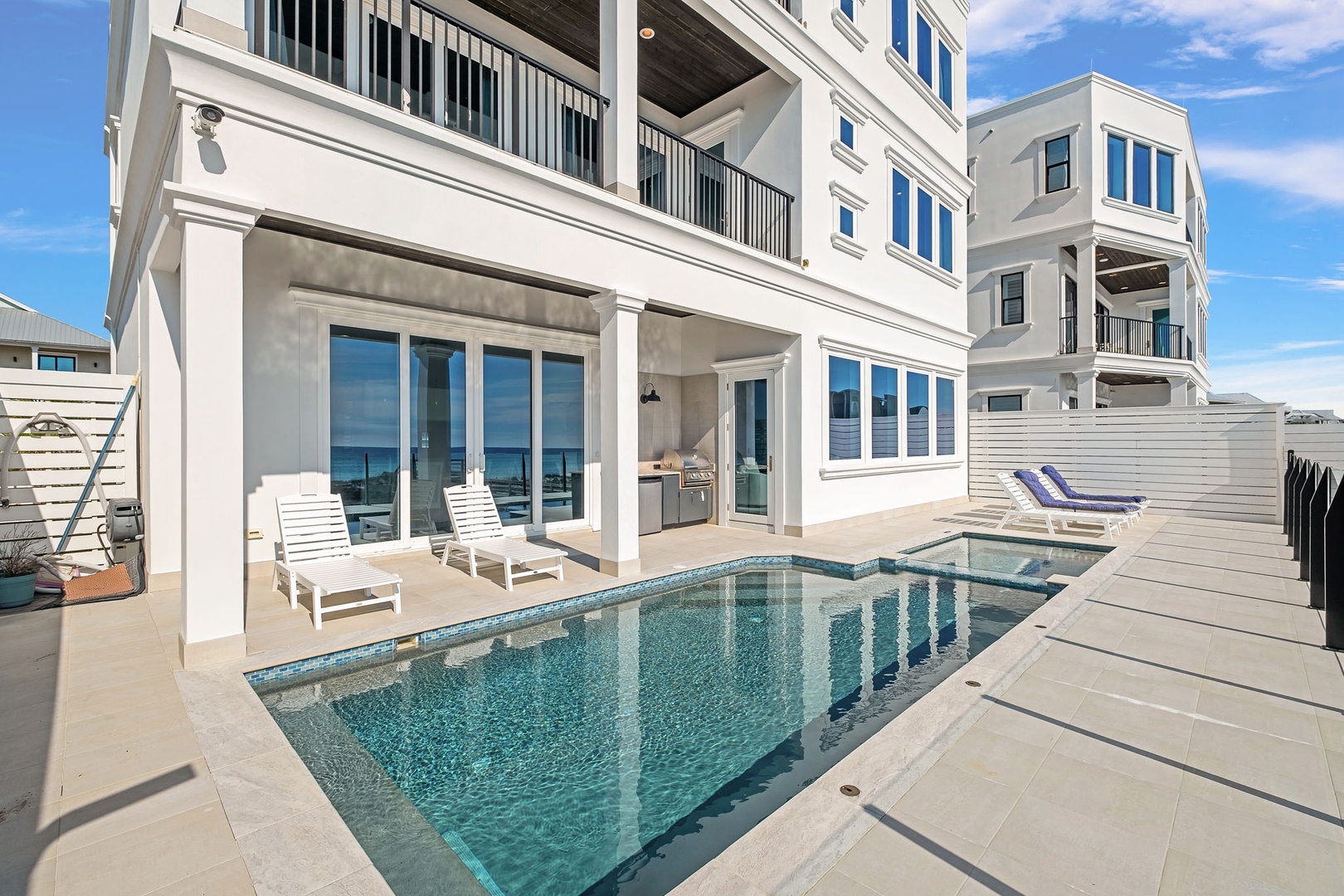Step onto your private pool deck where white loungers await beside crystal-clear waters, perfectly positioned for sun-soaked days of pure relaxation.