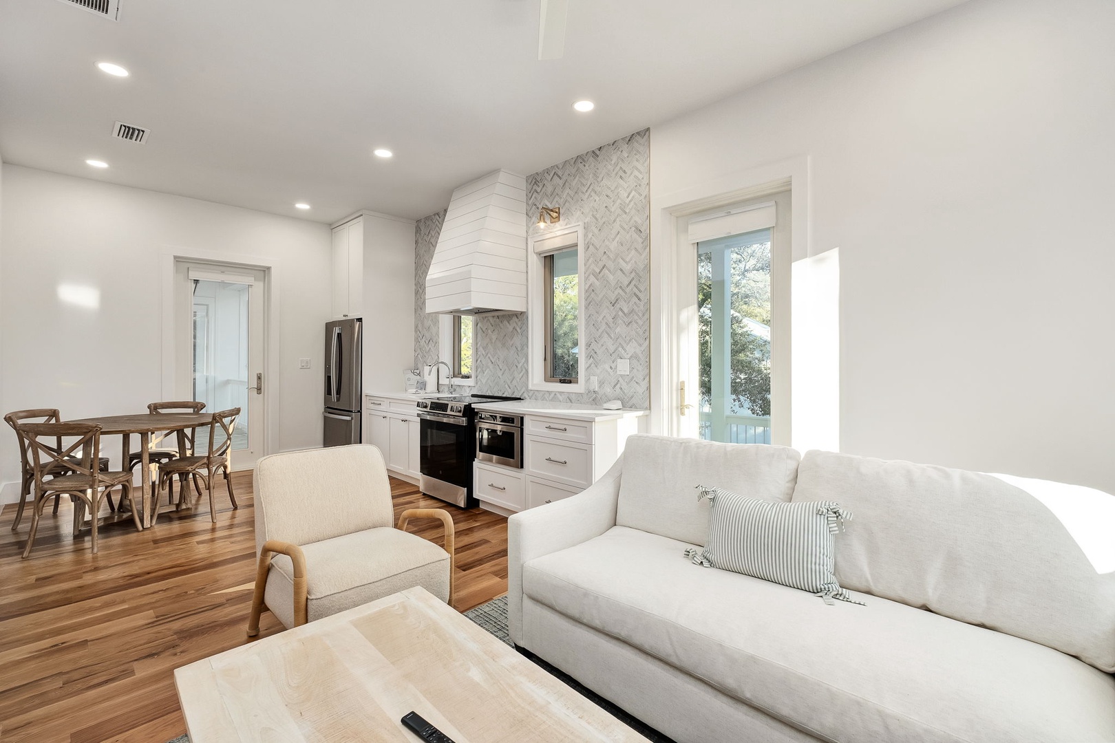Relax in your bright, open-concept space where modern design meets comfort, featuring gleaming hardwood floors and stylish furnishings throughout.