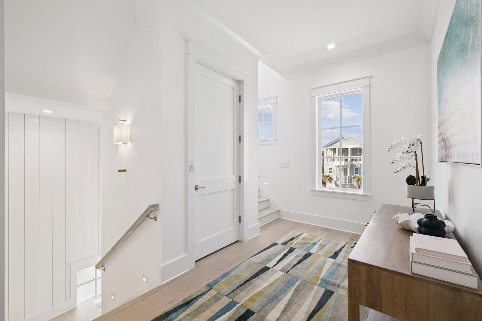 Unwind in your bright, modern space with clean lines and coastal views through expansive windows.