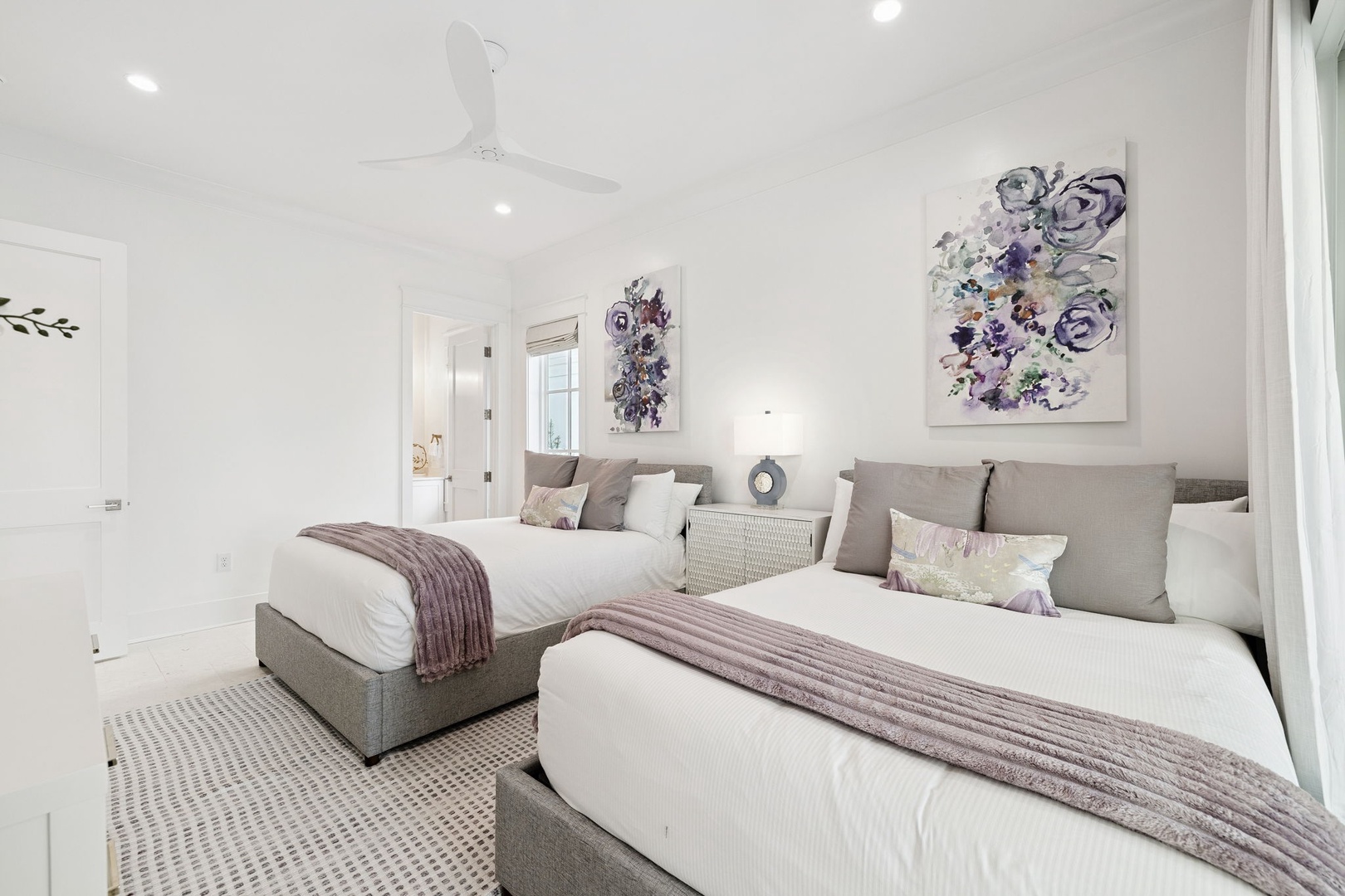 Drift into peaceful dreams in your elegant twin bedroom, where soft lavender accents and cozy throws create the perfect sanctuary for restful nights.