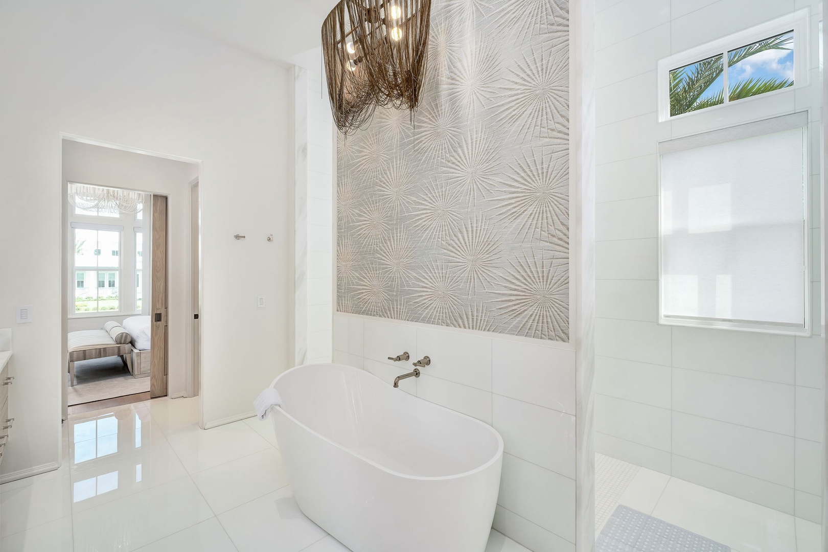 Slip into this stunning freestanding tub and let all your worries drift away. The elegant textured accent wall and soft natural light create a spa-like retreat where you can truly unwind.