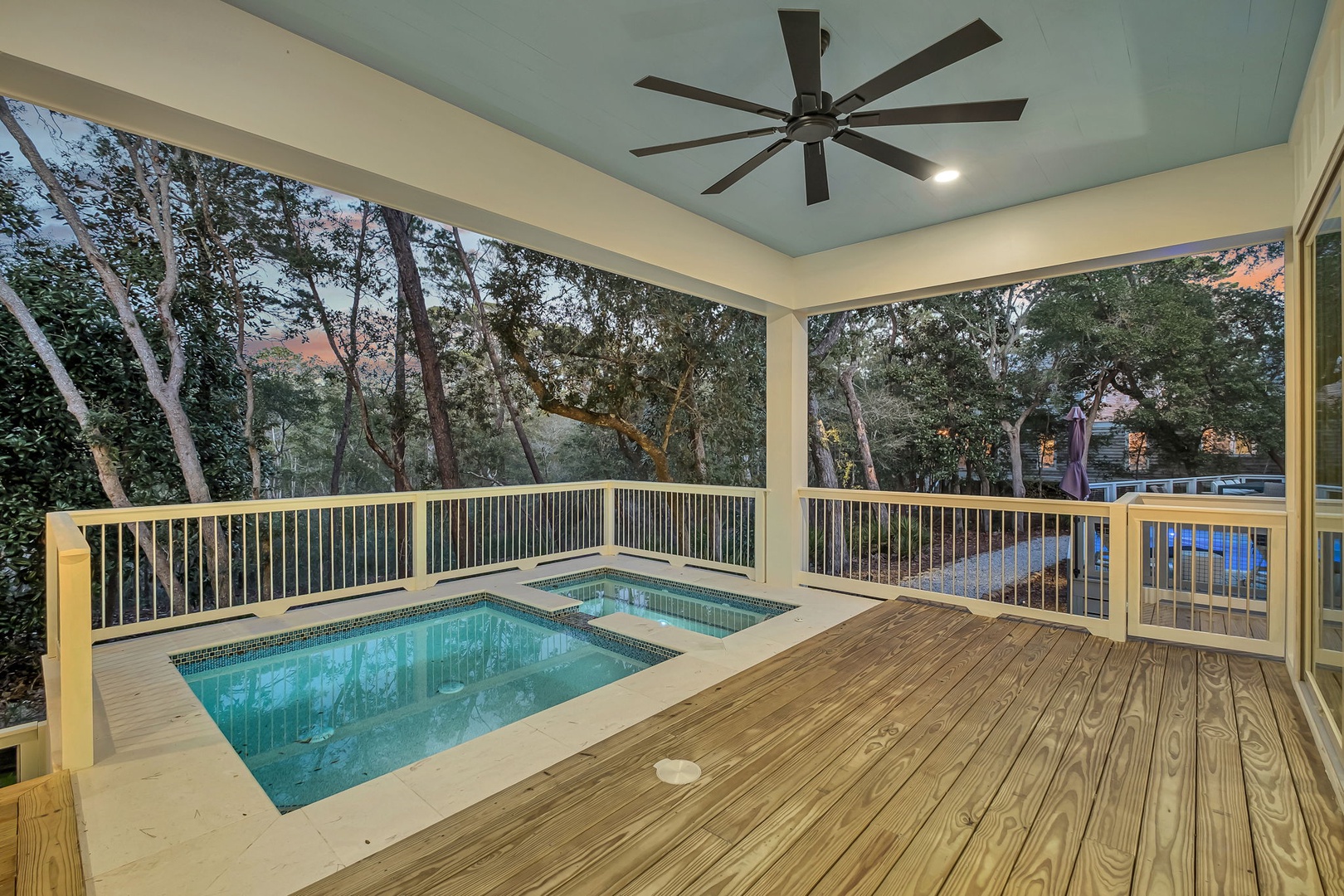 Your private covered deck features a sparkling hot tub where you can soak under the ceiling fan's gentle breeze.